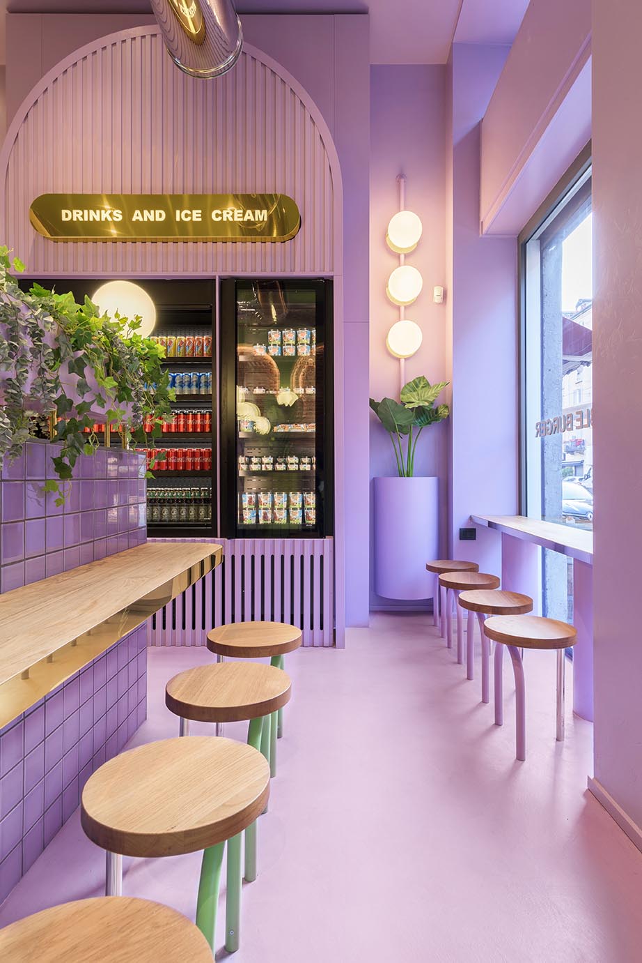 A new restaurant uses a colorful green and purple interior to draw people inside.