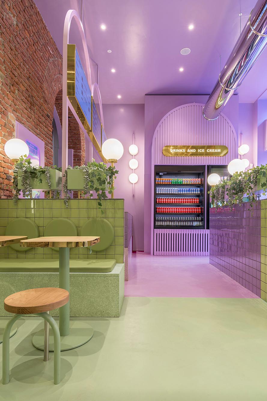 A new restaurant uses a colorful green and purple interior to draw people inside.