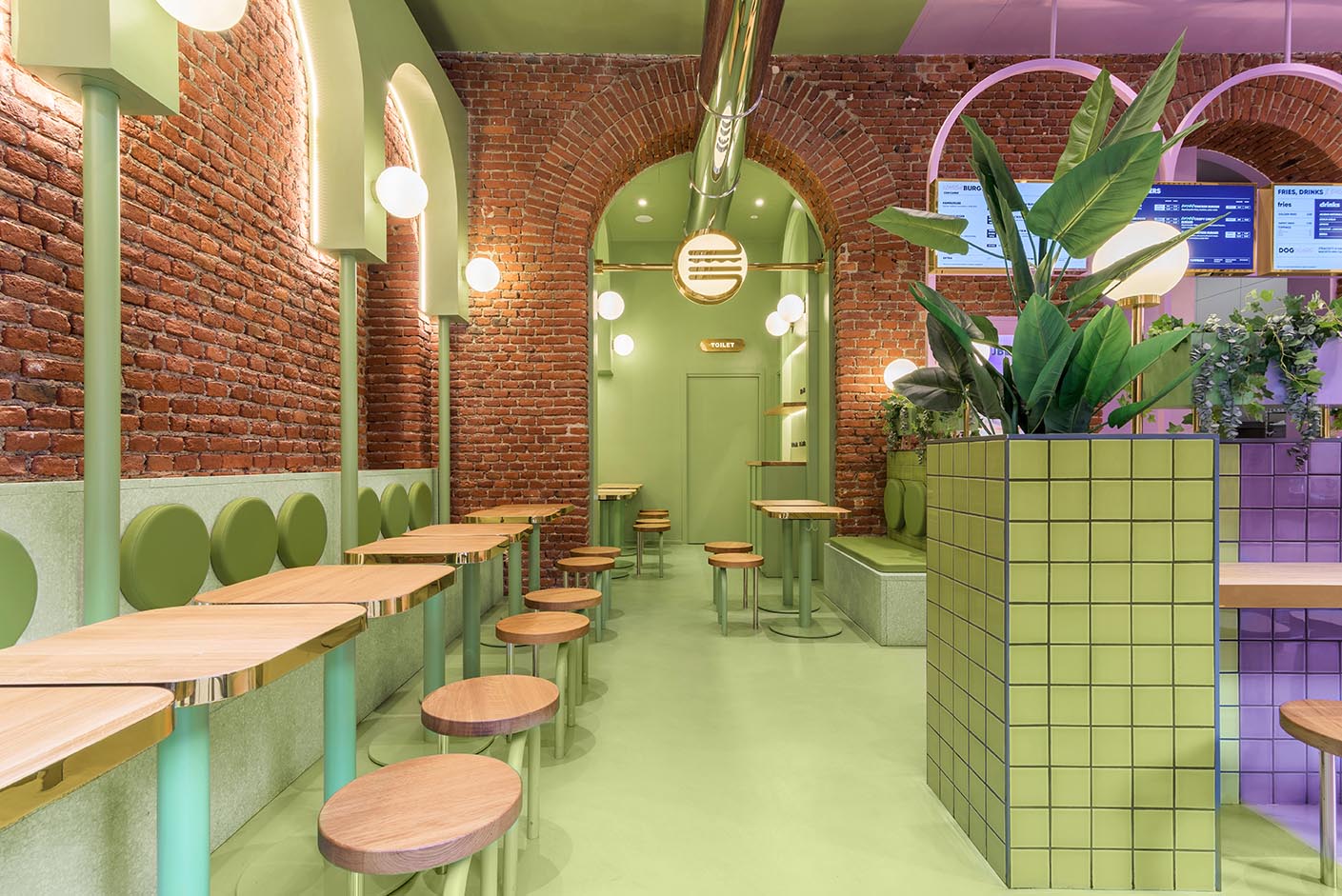 A new restaurant uses a colorful green and purple interior to draw people inside.
