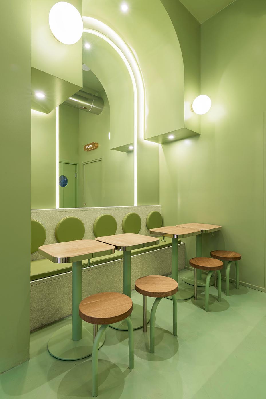 A new restaurant in Milan, Italy, uses a colorful green interior design to draw people inside.