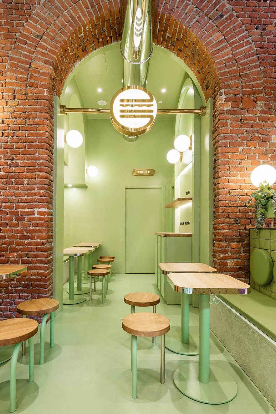 A new restaurant uses a colorful green interior to draw people inside.