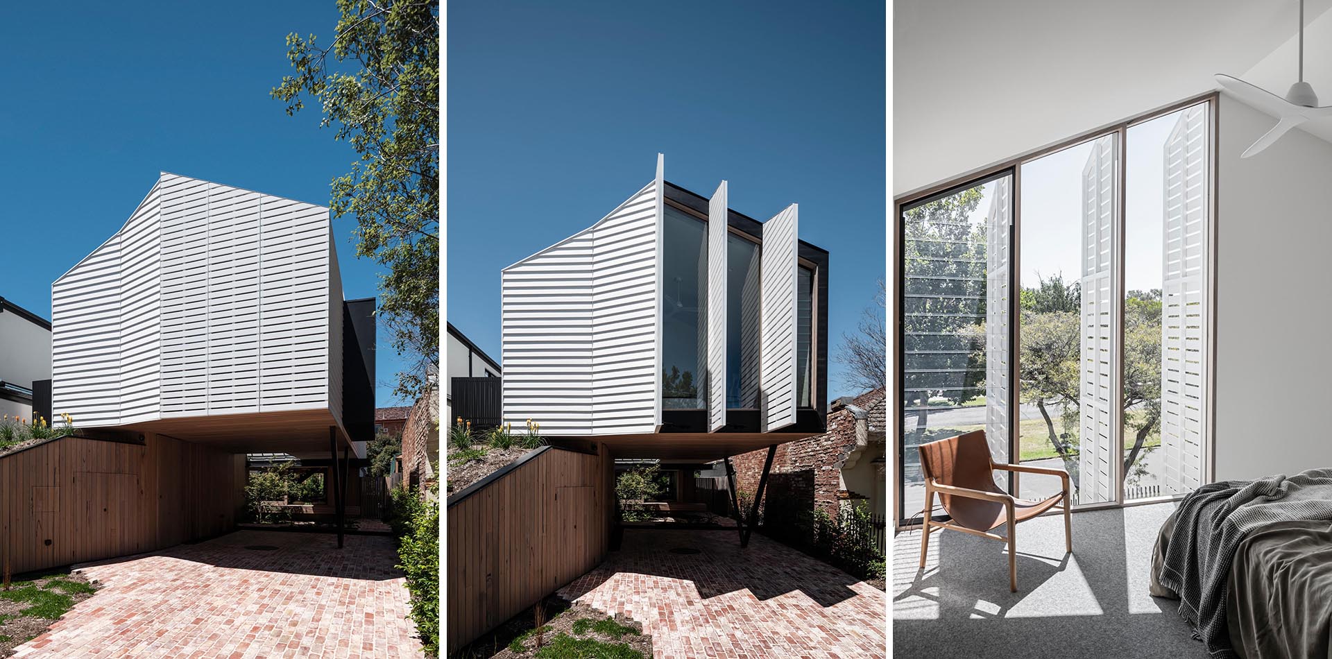 A modern home with a white exterior incorporates mechanically operated shutters that seamlessly match the siding on the house.