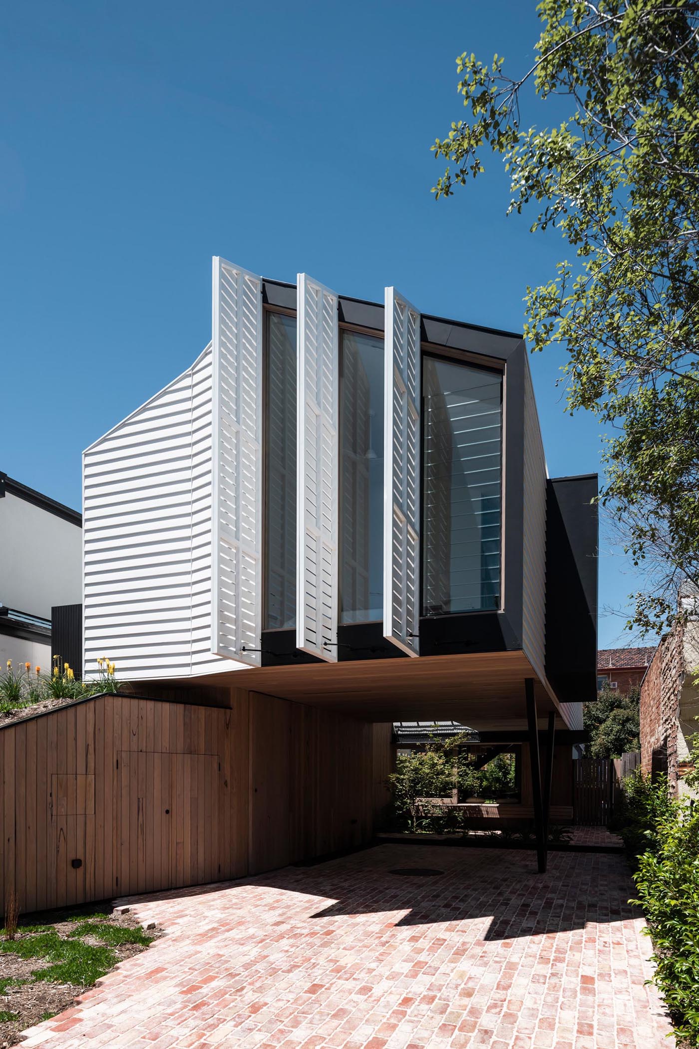 A modern house with operable exterior shutters.