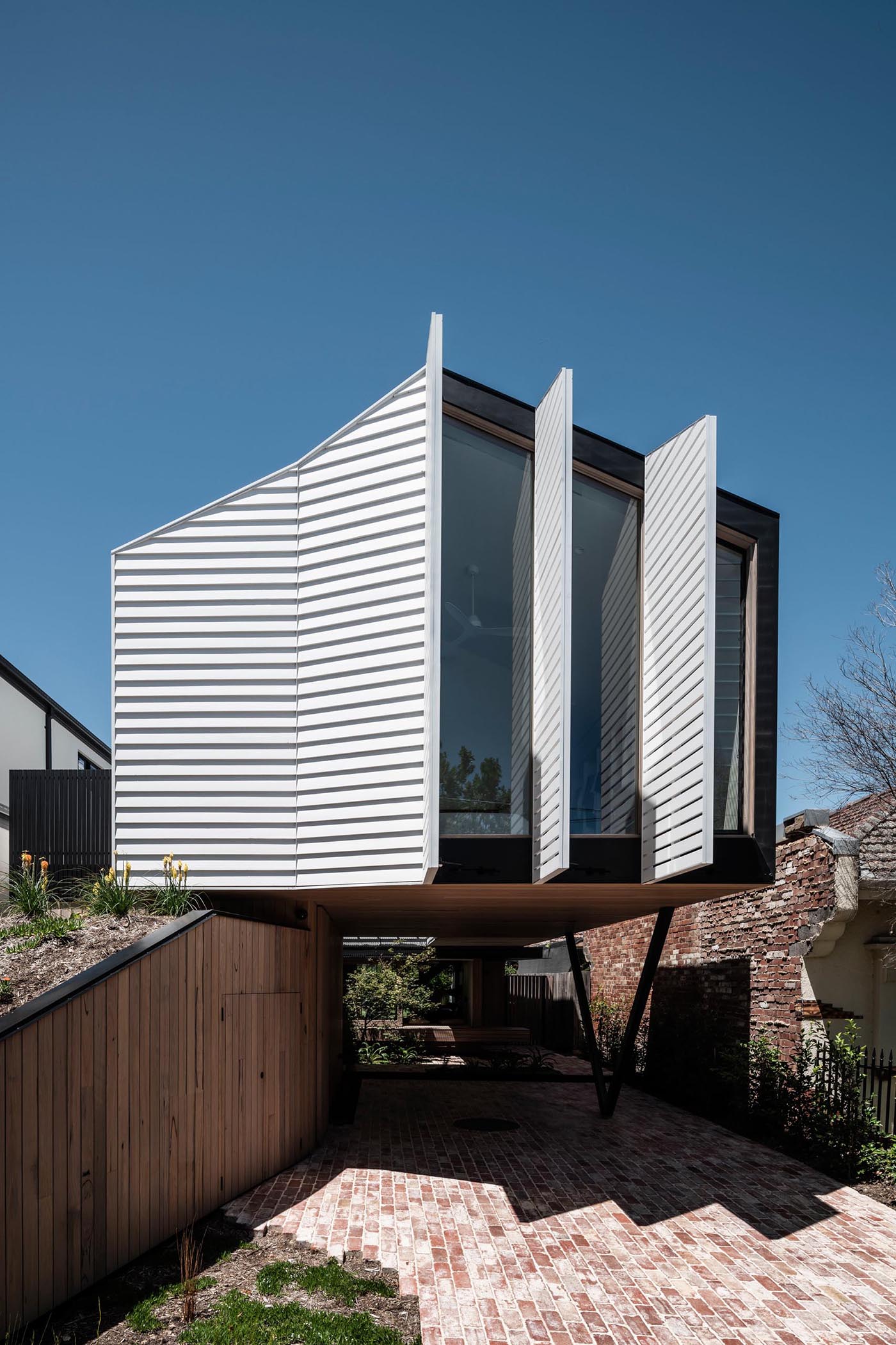 A modern house with operable exterior shutters.