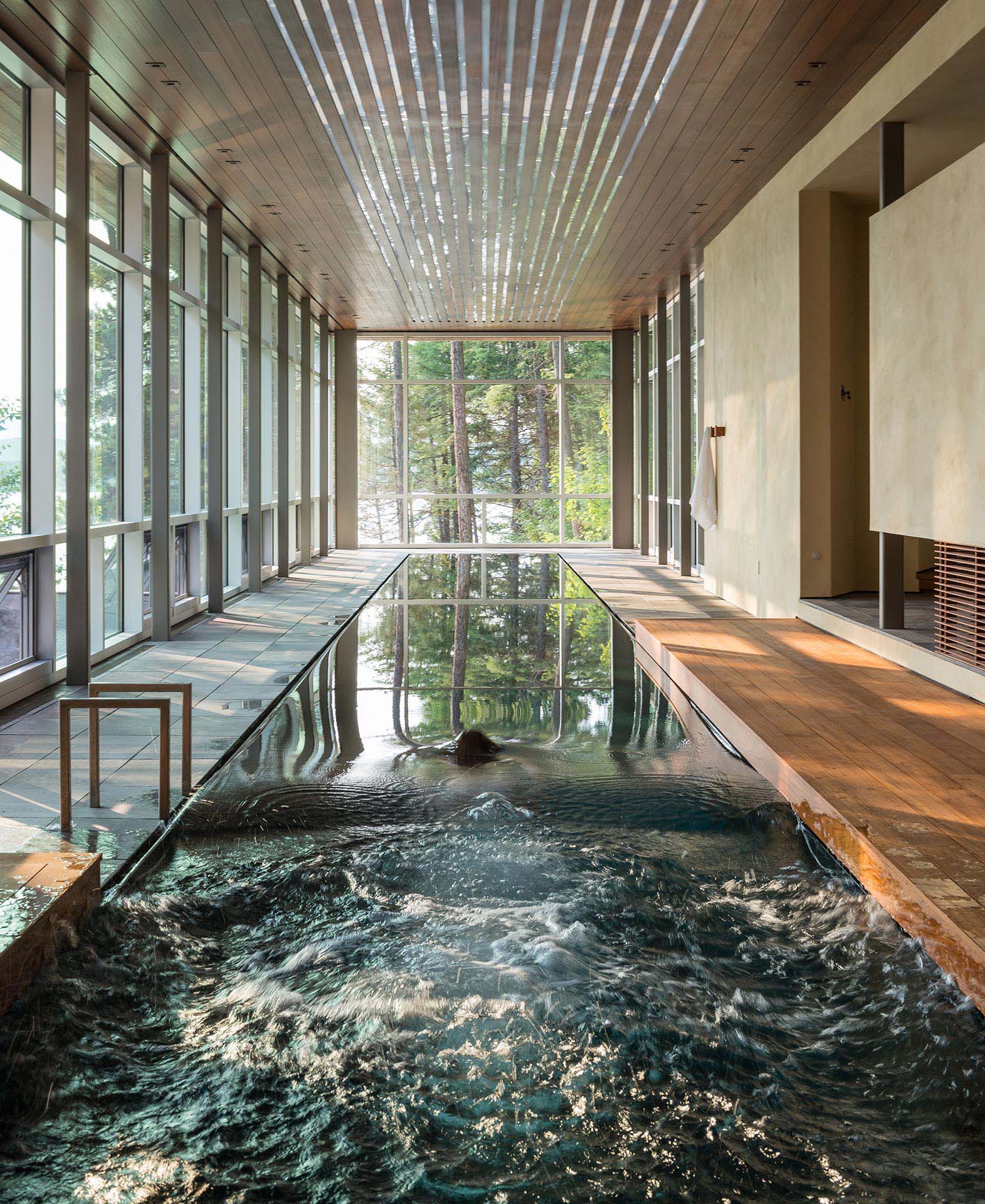 A 75-foot-long, single-lane lap pool is naturally lit by the floor to ceiling windows during the day.