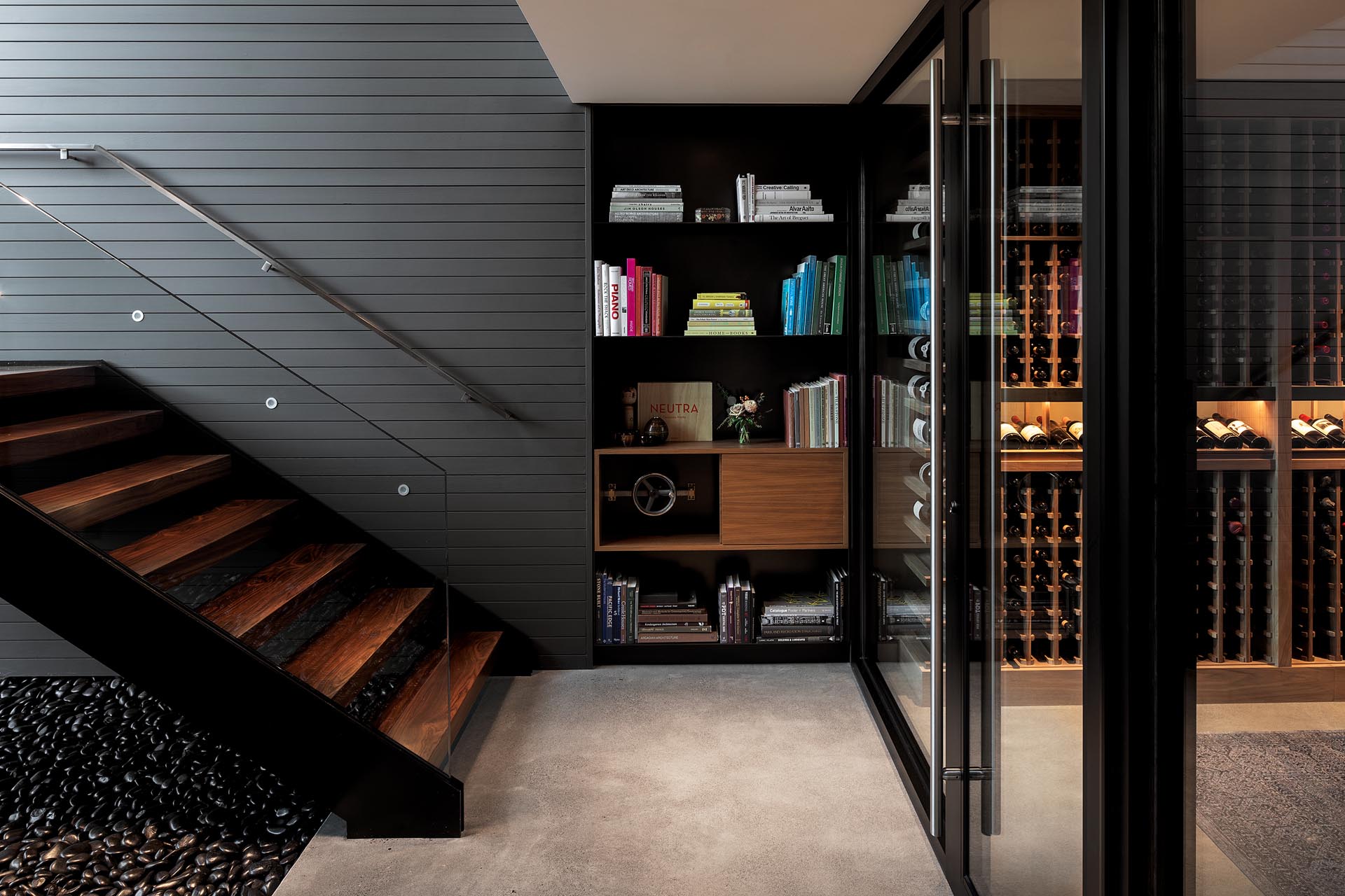This modern house has a hidden whiskey room - accessed through a secret latch in the bookshelf at the bottom of the stairs.