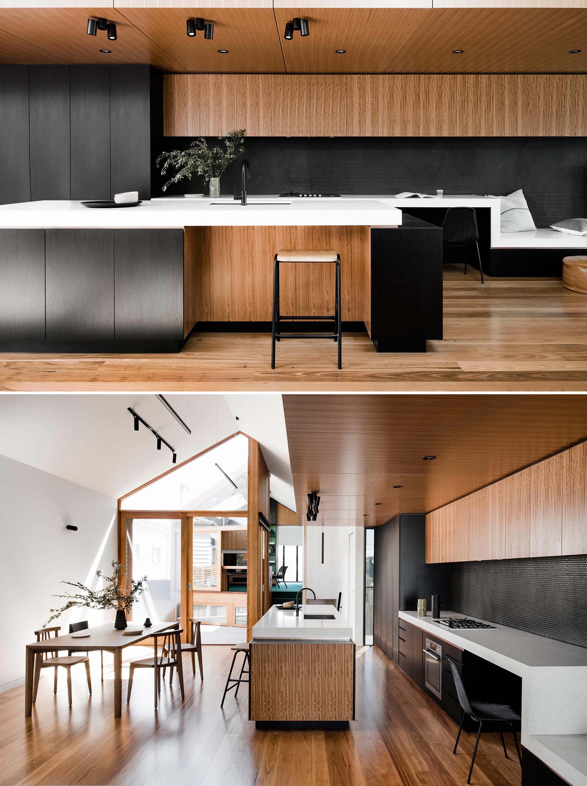 A modern kitchen with black cabinets and wood accents, has a white countertop that transforms into a desk, TV stand, and window bench.