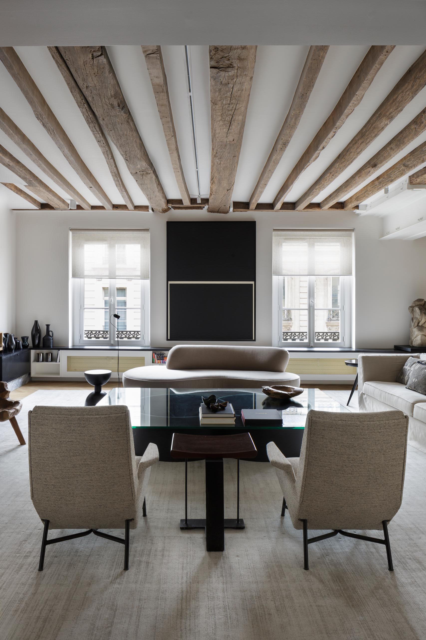 In this modern living room, neutral colored furniture creates a calm and relaxed environment.