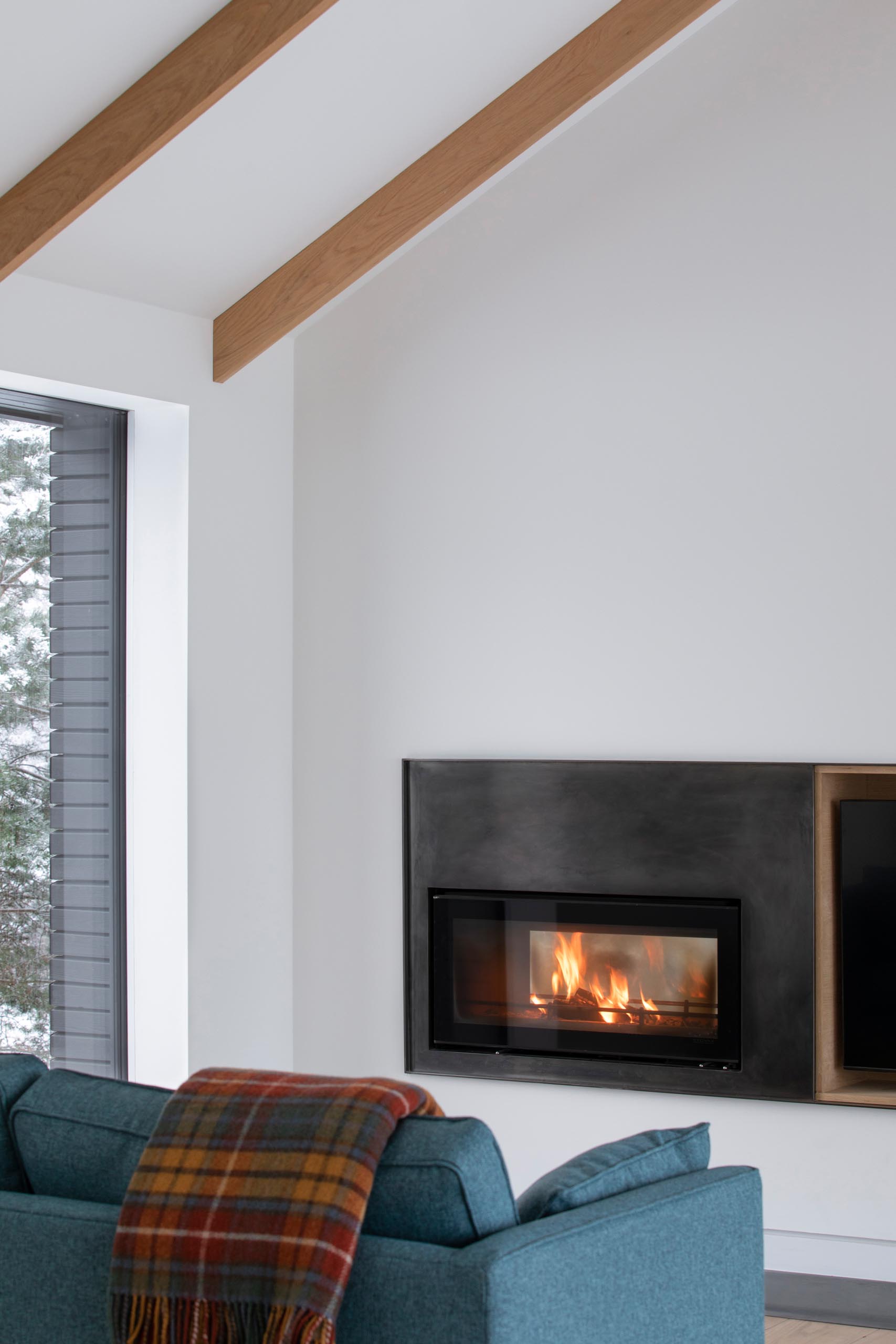 A modern living room with a steel fireplace surround.