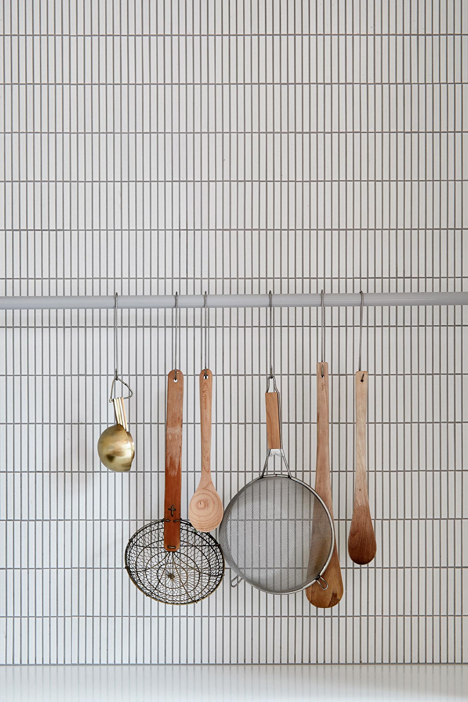 A modern kitchen with small rectangular tiles.