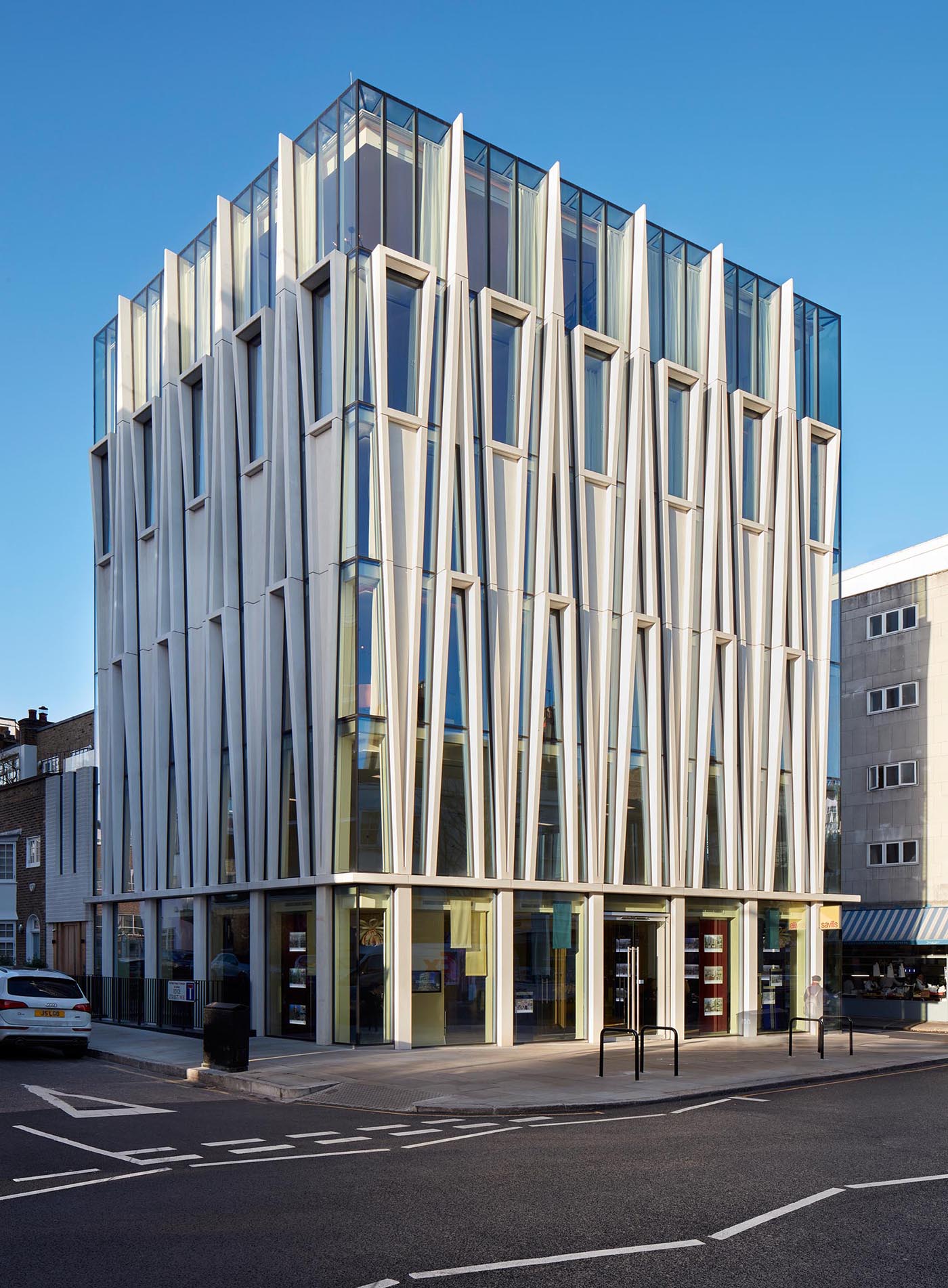 A modern mixed-use building with a facade inspired by candle-making.