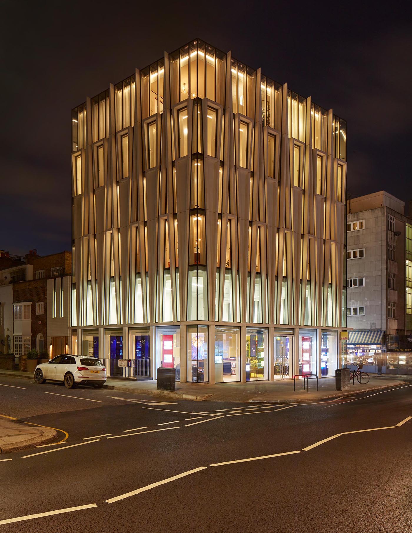 A modern mixed-use building with a facade inspired by candle-making.