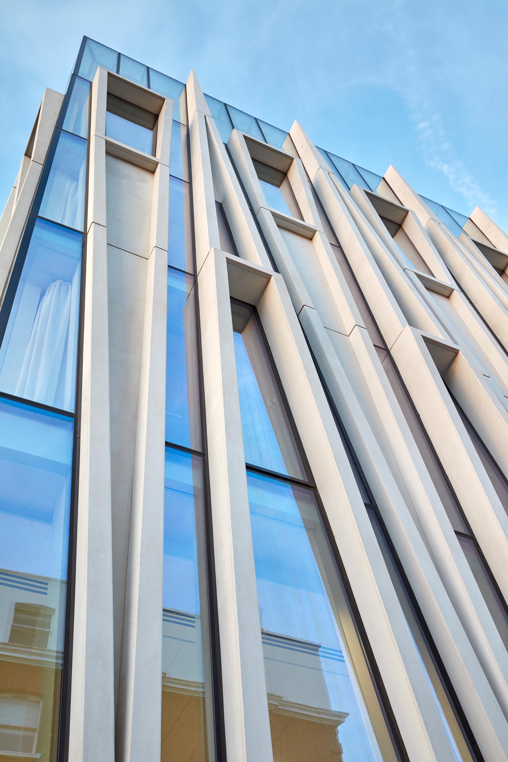 A modern mixed-use building with a facade inspired by candle-making.