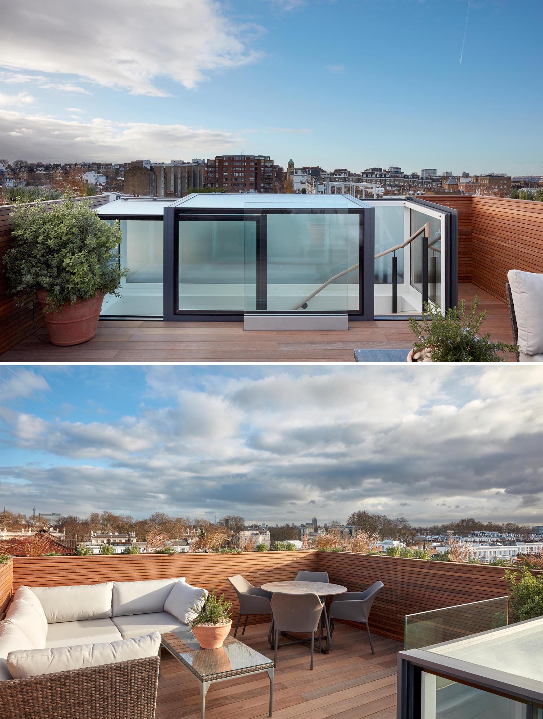A modern wood-lined rooftop deck with a lounge and dining area.