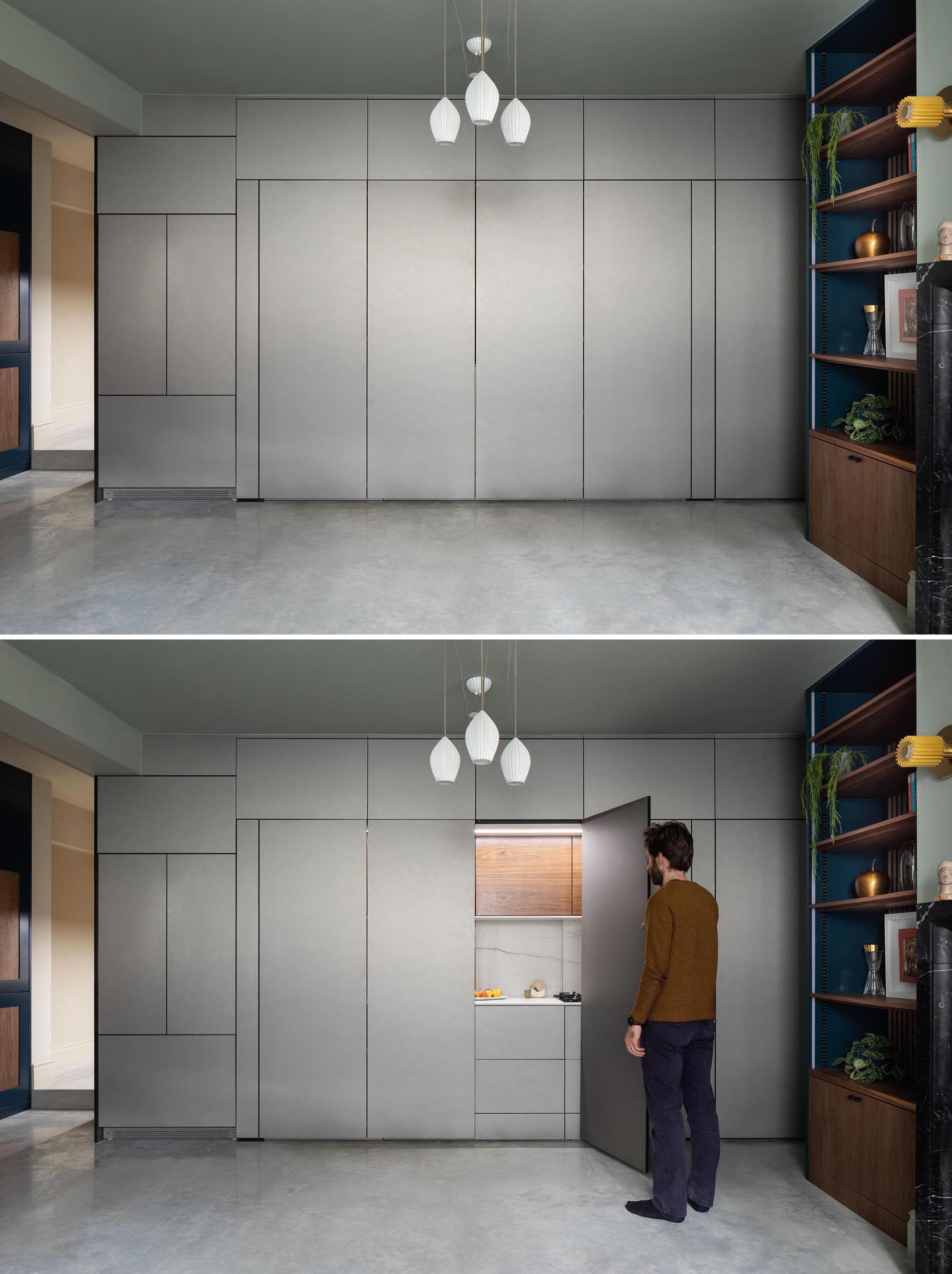 This modern kitchen, which can hidden away when not in use, is enclosed in muted metallic gray cabinets. The main section of the kitchen is accessed via a pair of folding doors.