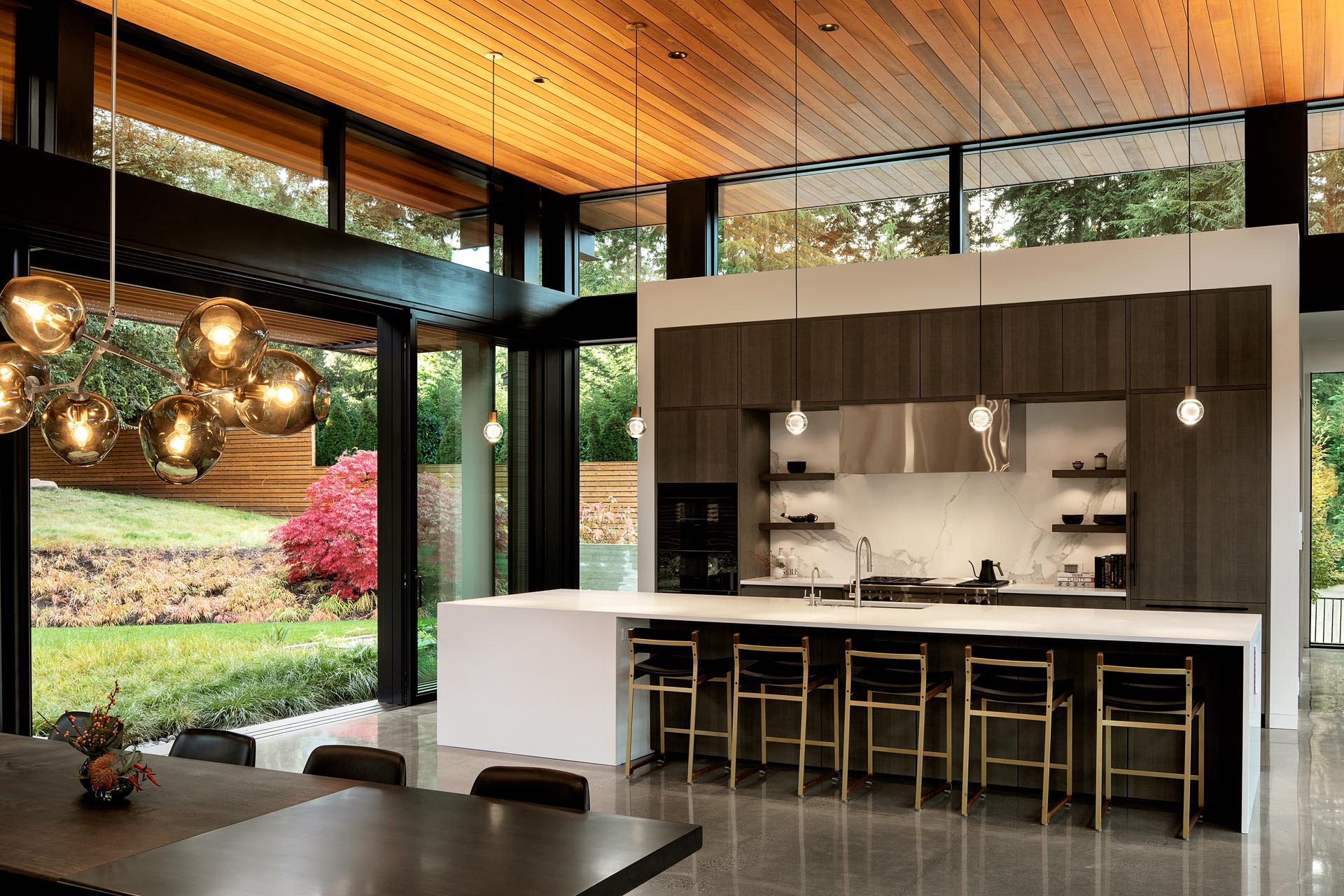 A modern wood and white kitchen with a long island.
