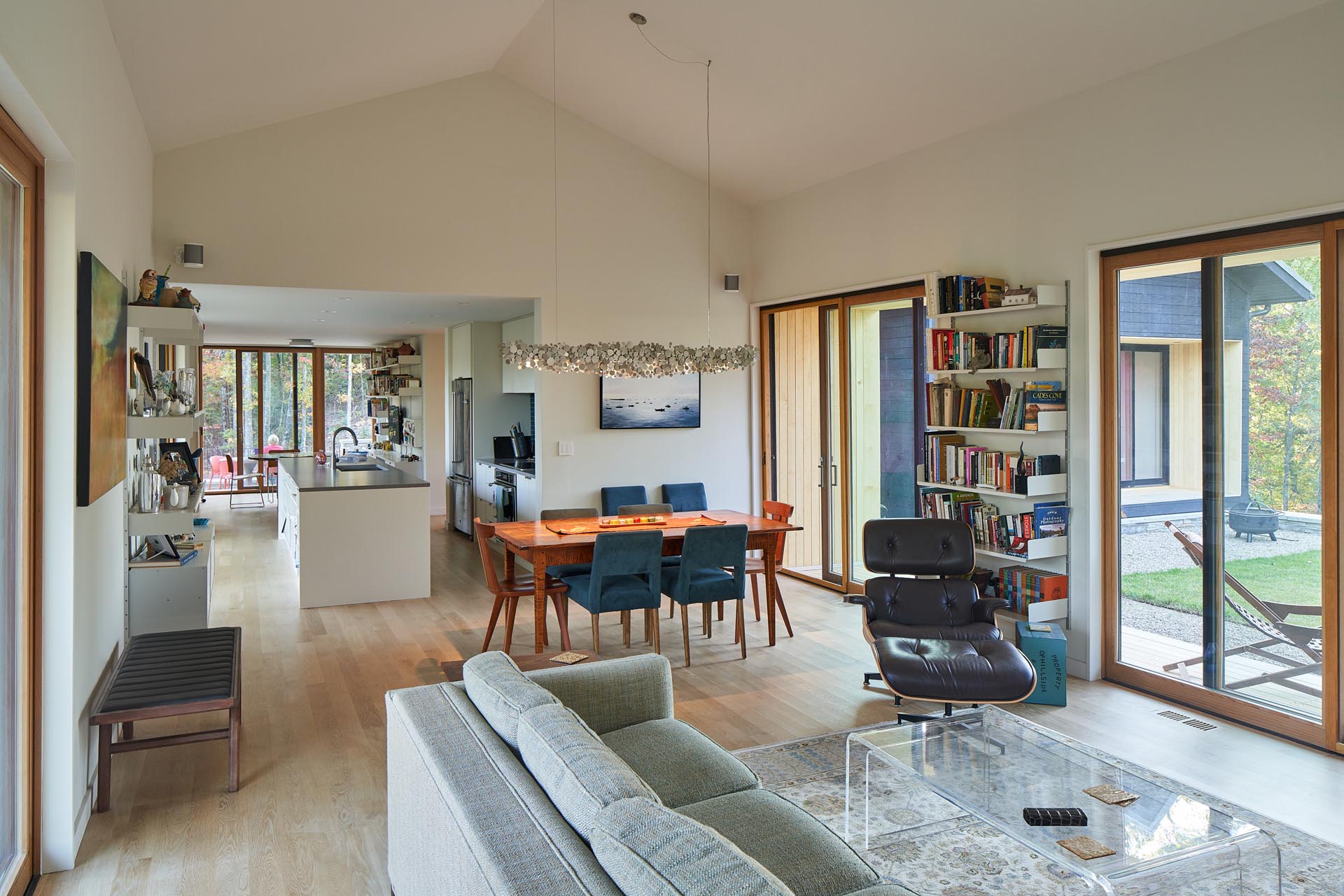 An open plan living room and dining area that has a vaulted ceiling, making the space feel larger.