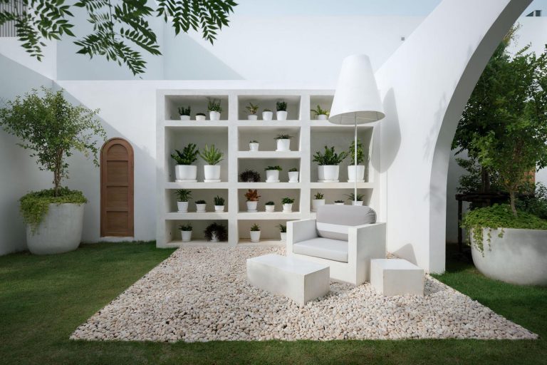 This Landscaped Outdoor Space Includes A Living Room With A Bookshelf For Plants
