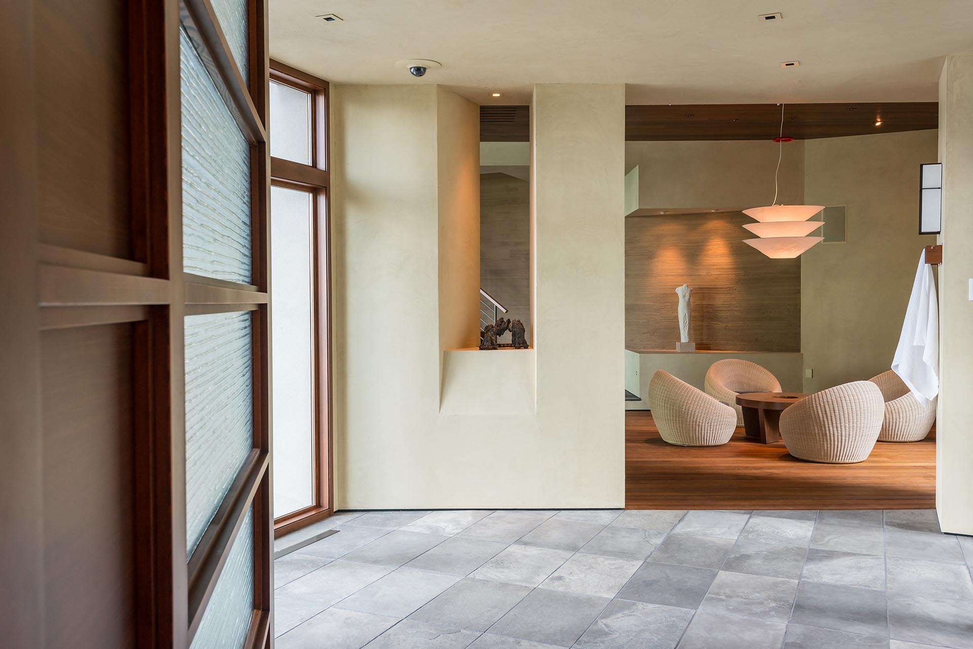 A modern pool house with teak and limestone flooring.