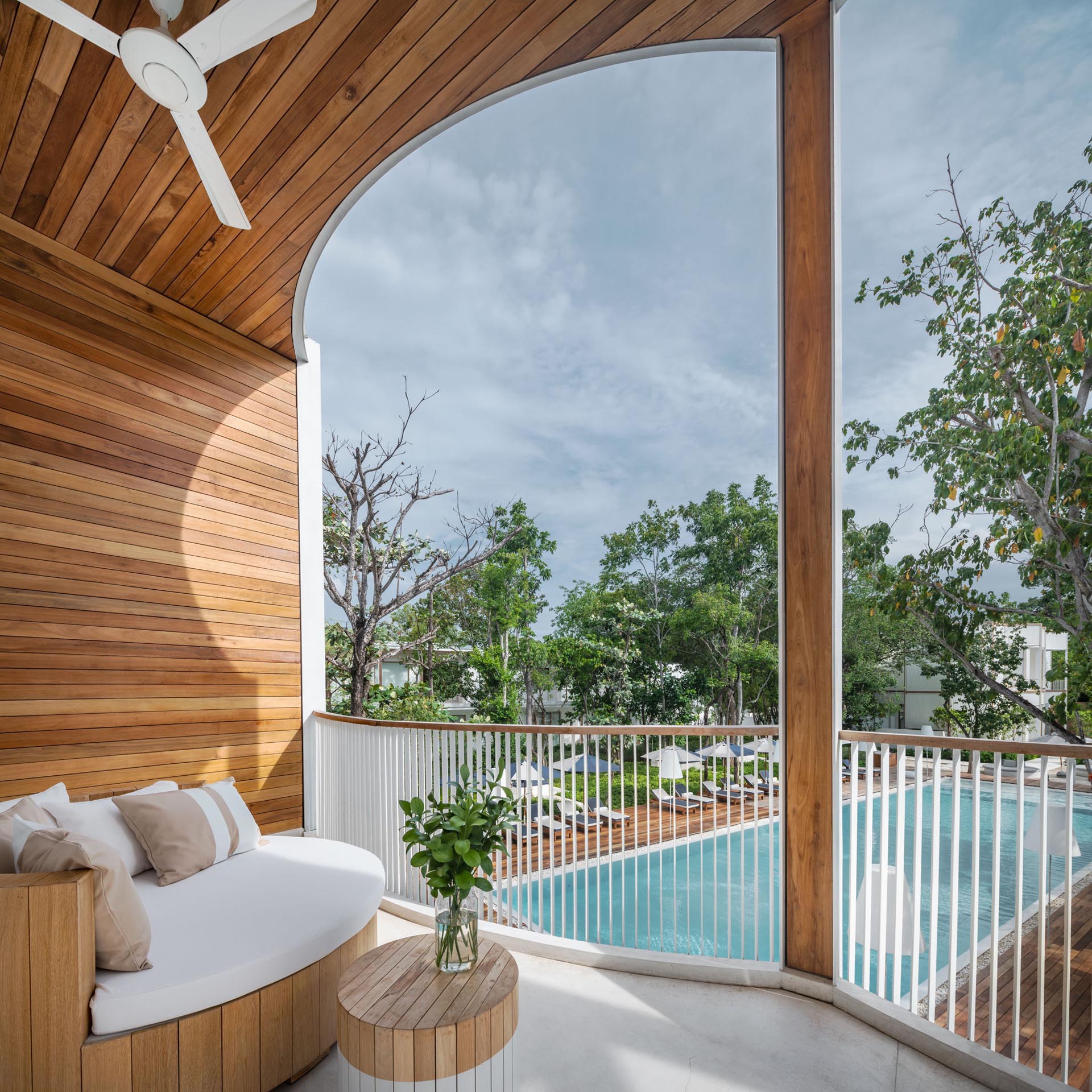 A hotel balcony with views of the pool below.