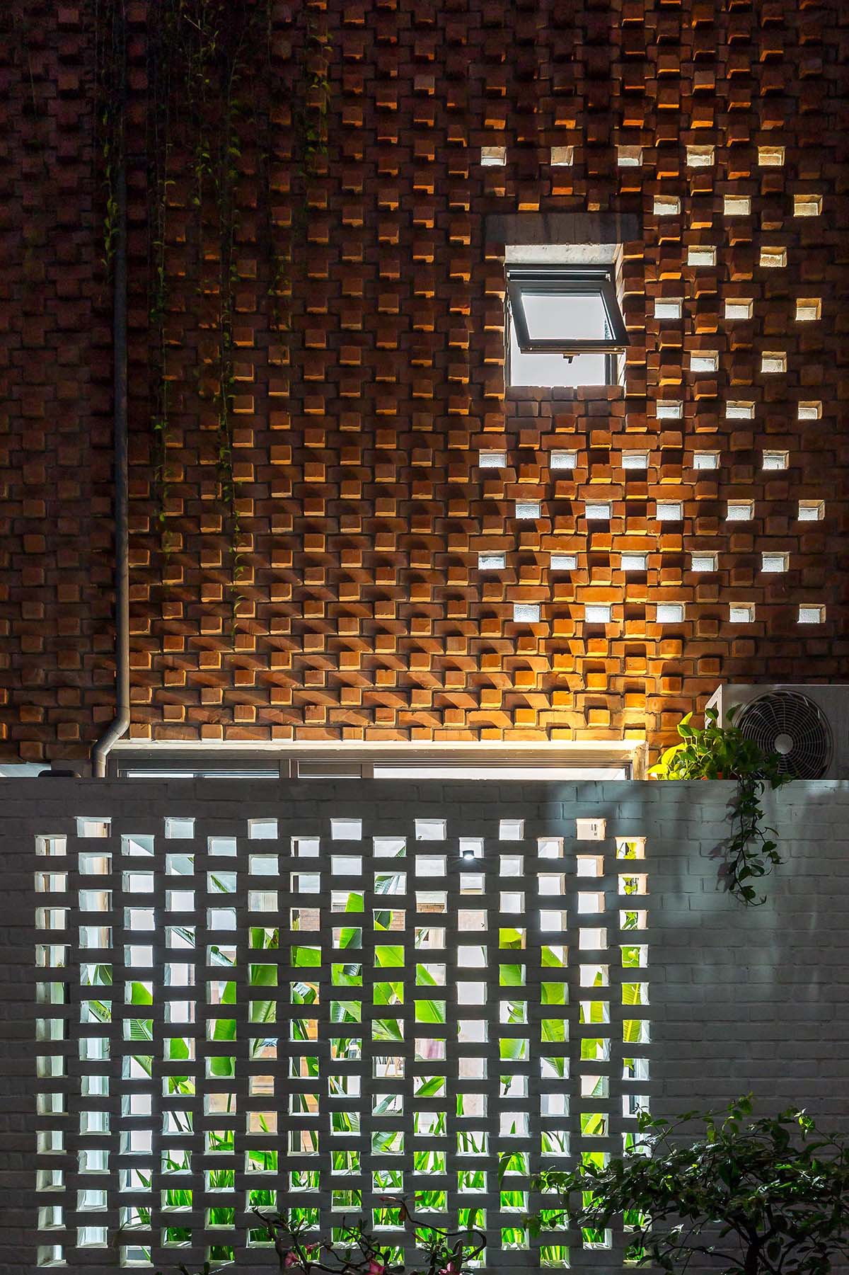 A modern home with painted brick lower level, and textured brick upper level.