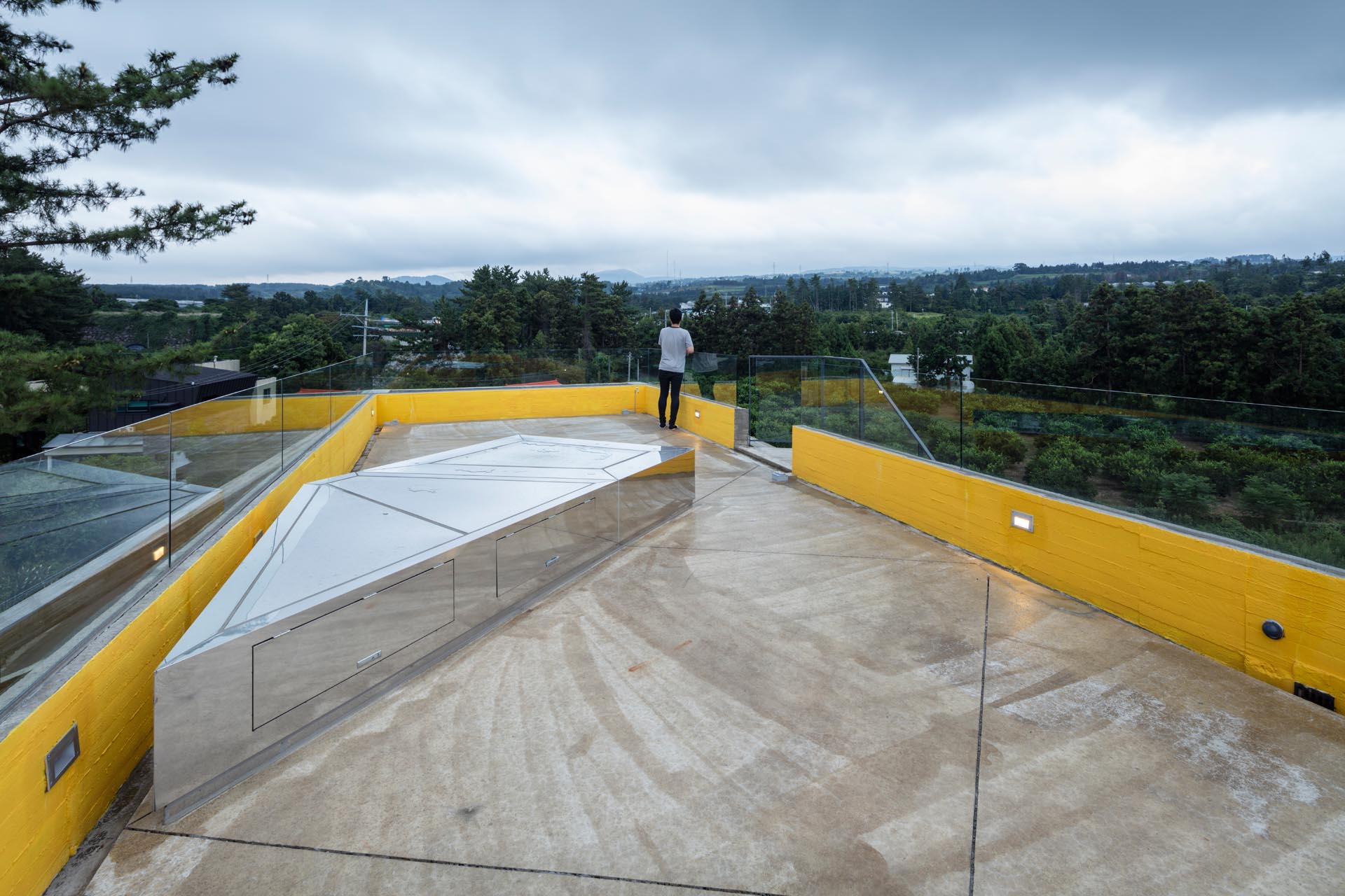 The rooftop deck of a modern concrete house.