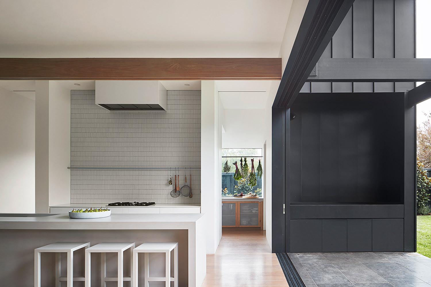 Sliding glass doors connect the interior spaces with the patio and backyard.