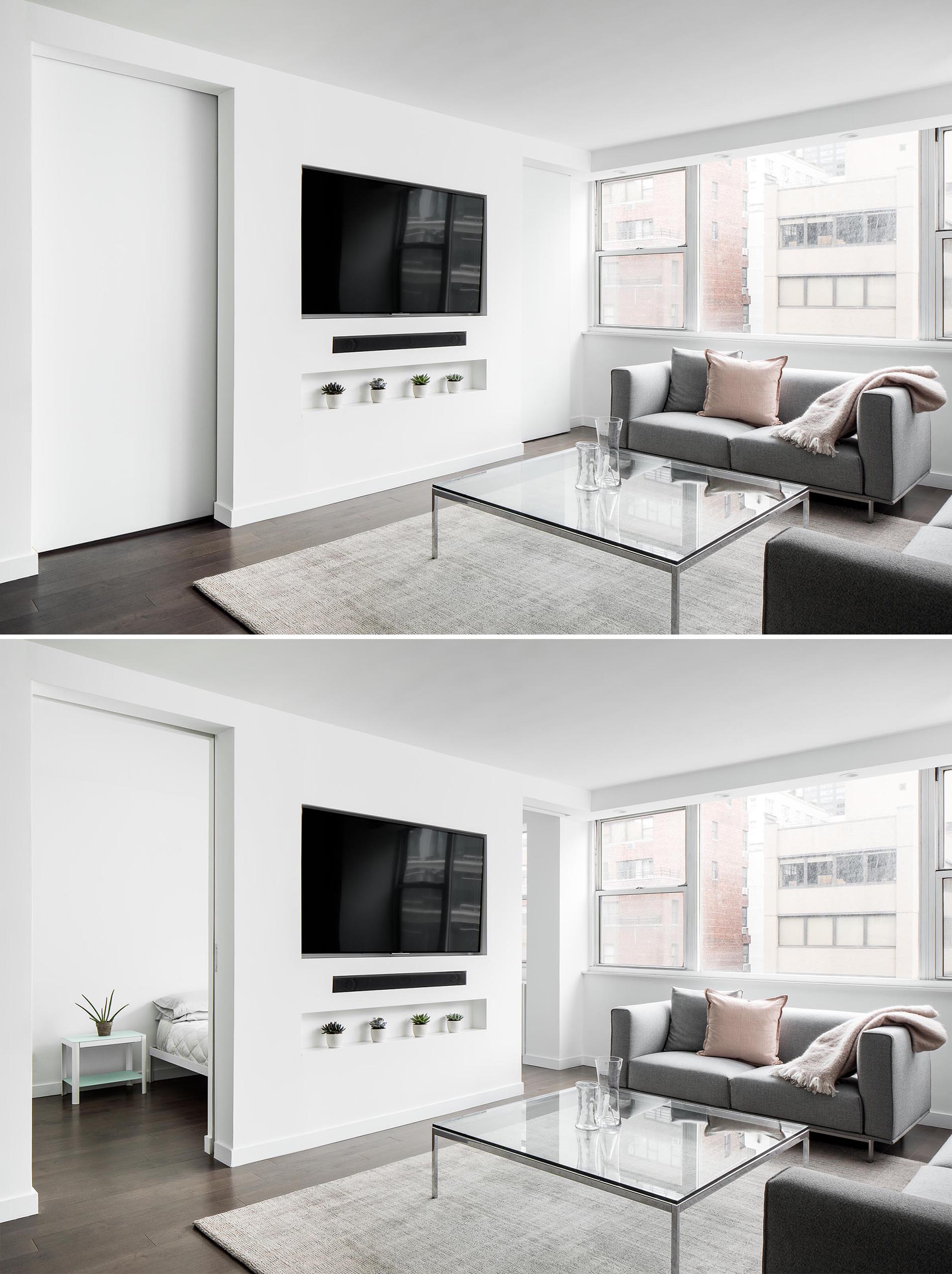 This small and modern living room is flooded with natural light while the recessed television is located above a shelving niche. Sliding doors on either side of the television wall lead to the bedroom.