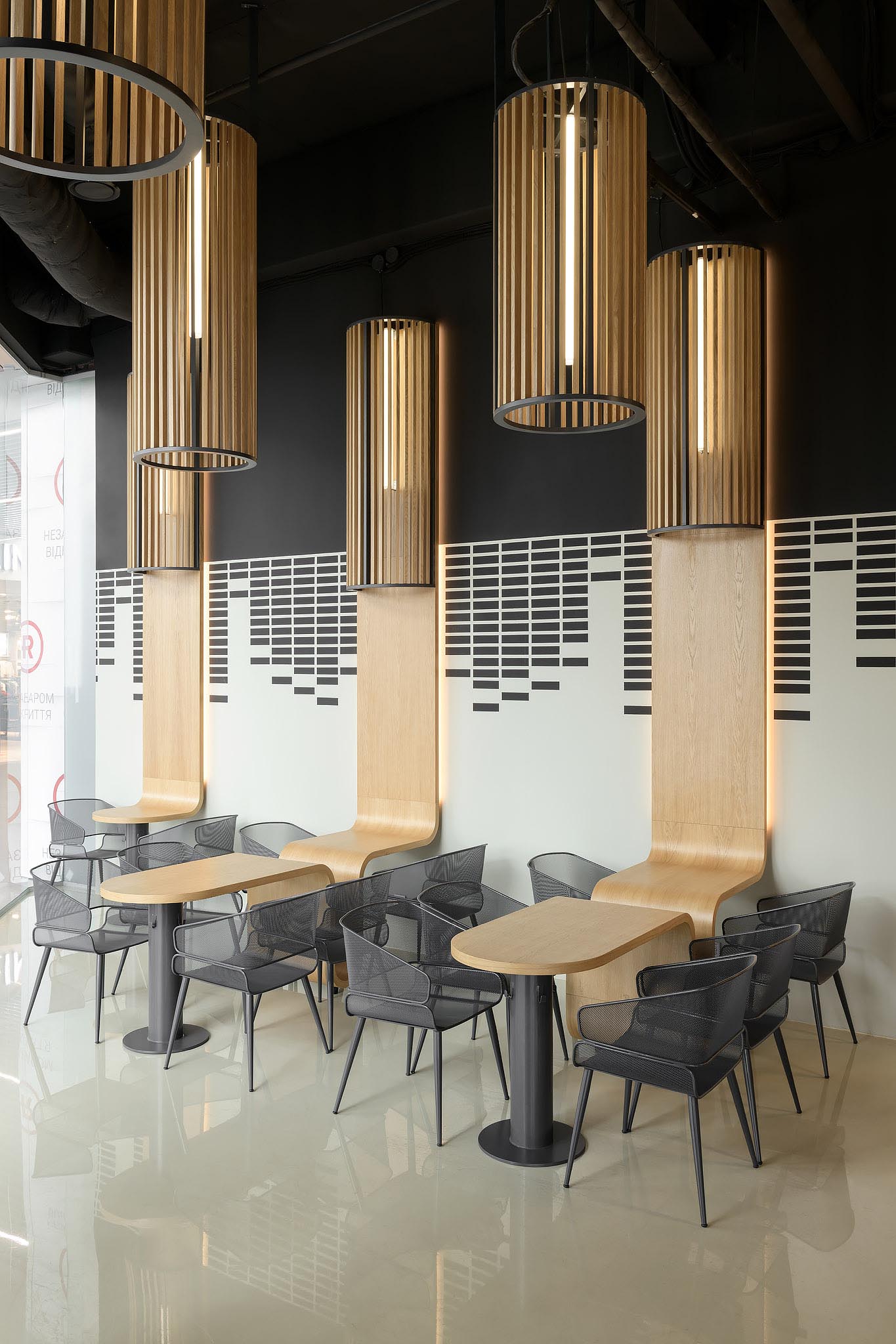 A modern coffee shop with custom designed oak tables.