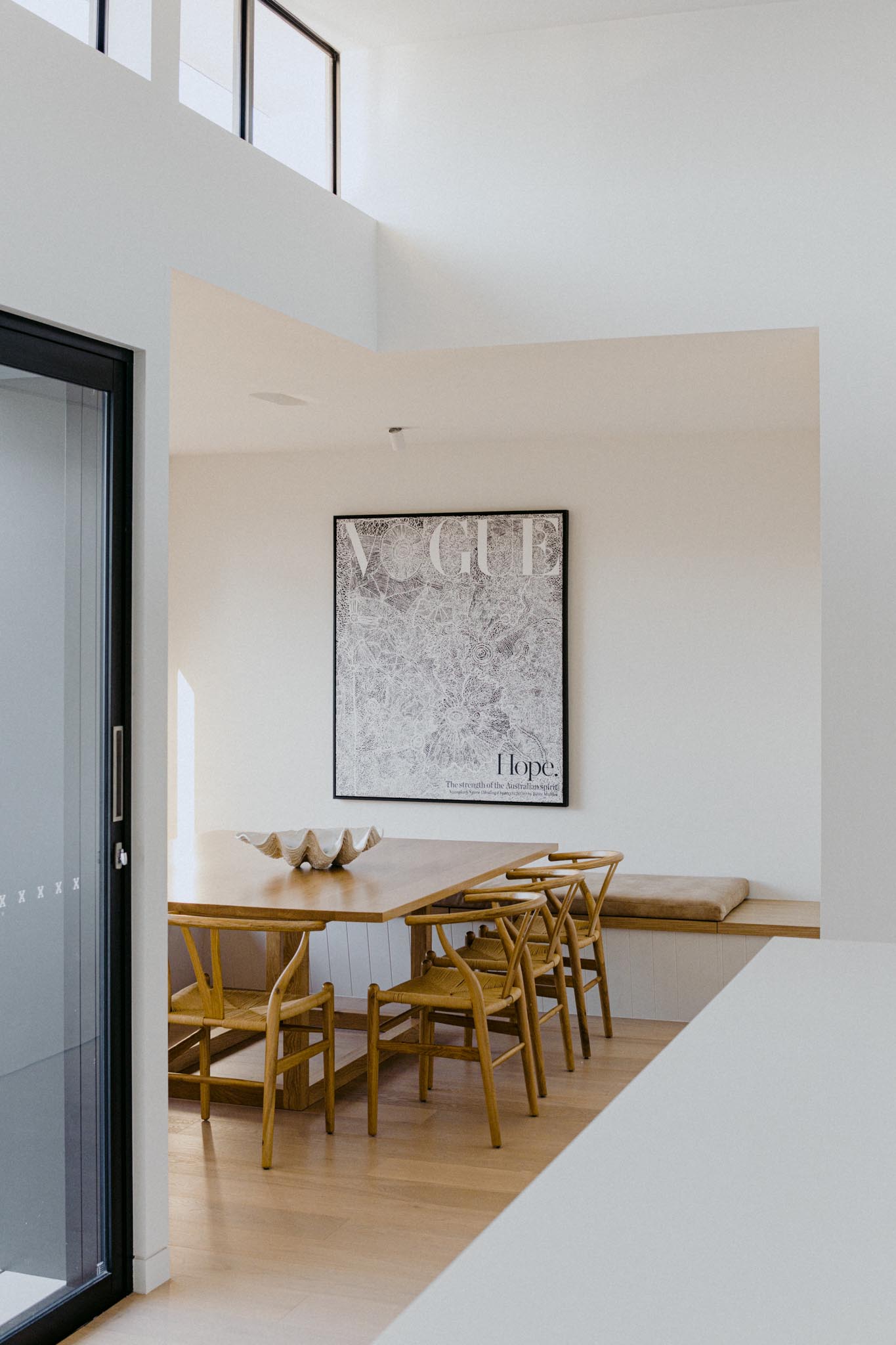 A modern dining room with benches that wrap around the corner of the room and provide plenty of seating when combined with the dining chairs.