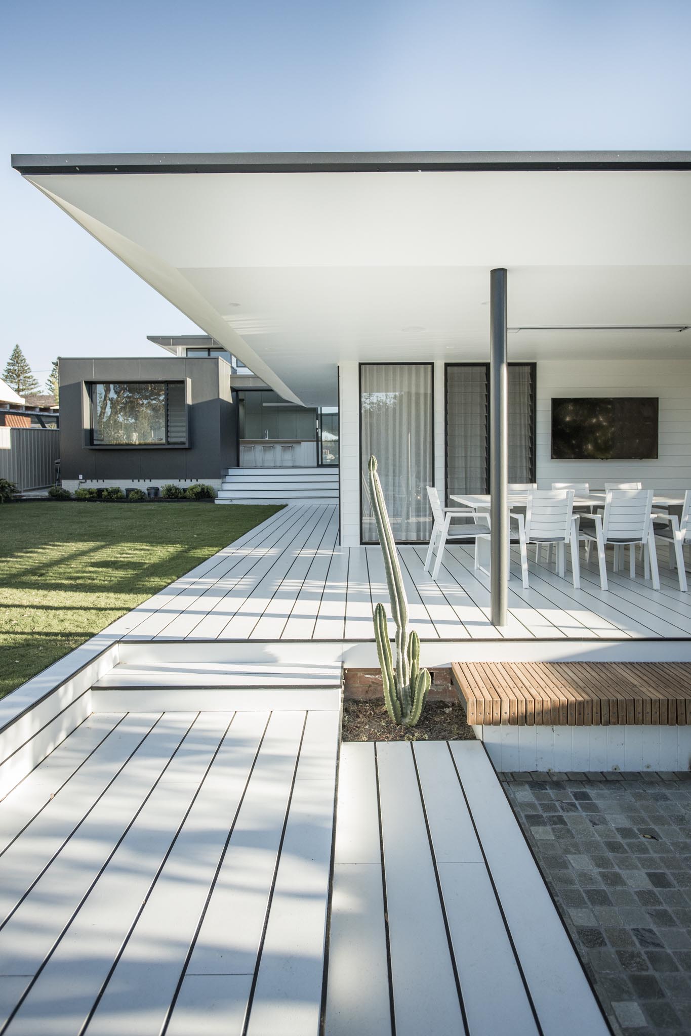 The rear of this modern home includes a pool and expansive yard, where the home owners can relax and give the children space to roam.