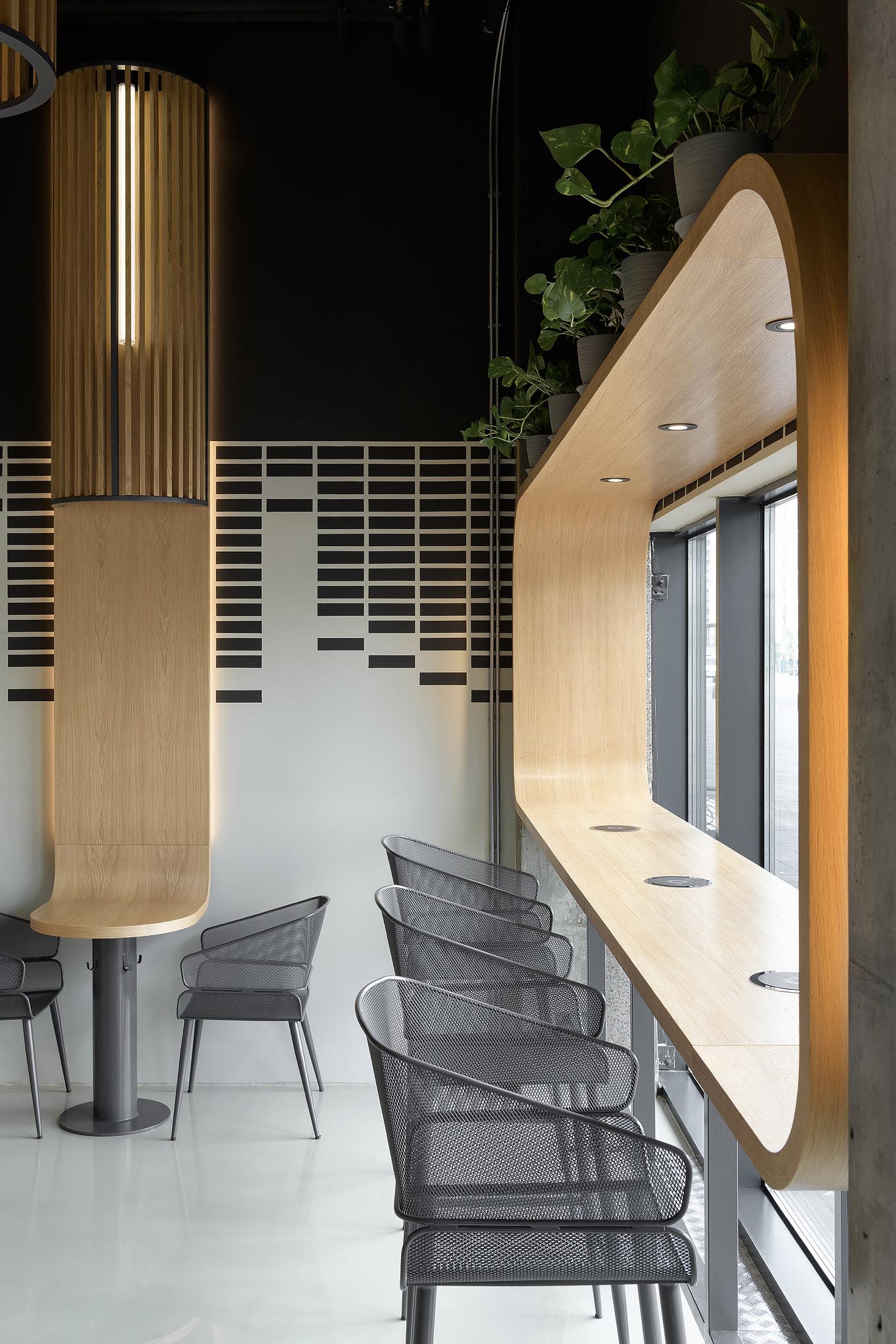 A modern coffee shop with wood-lined window seating.