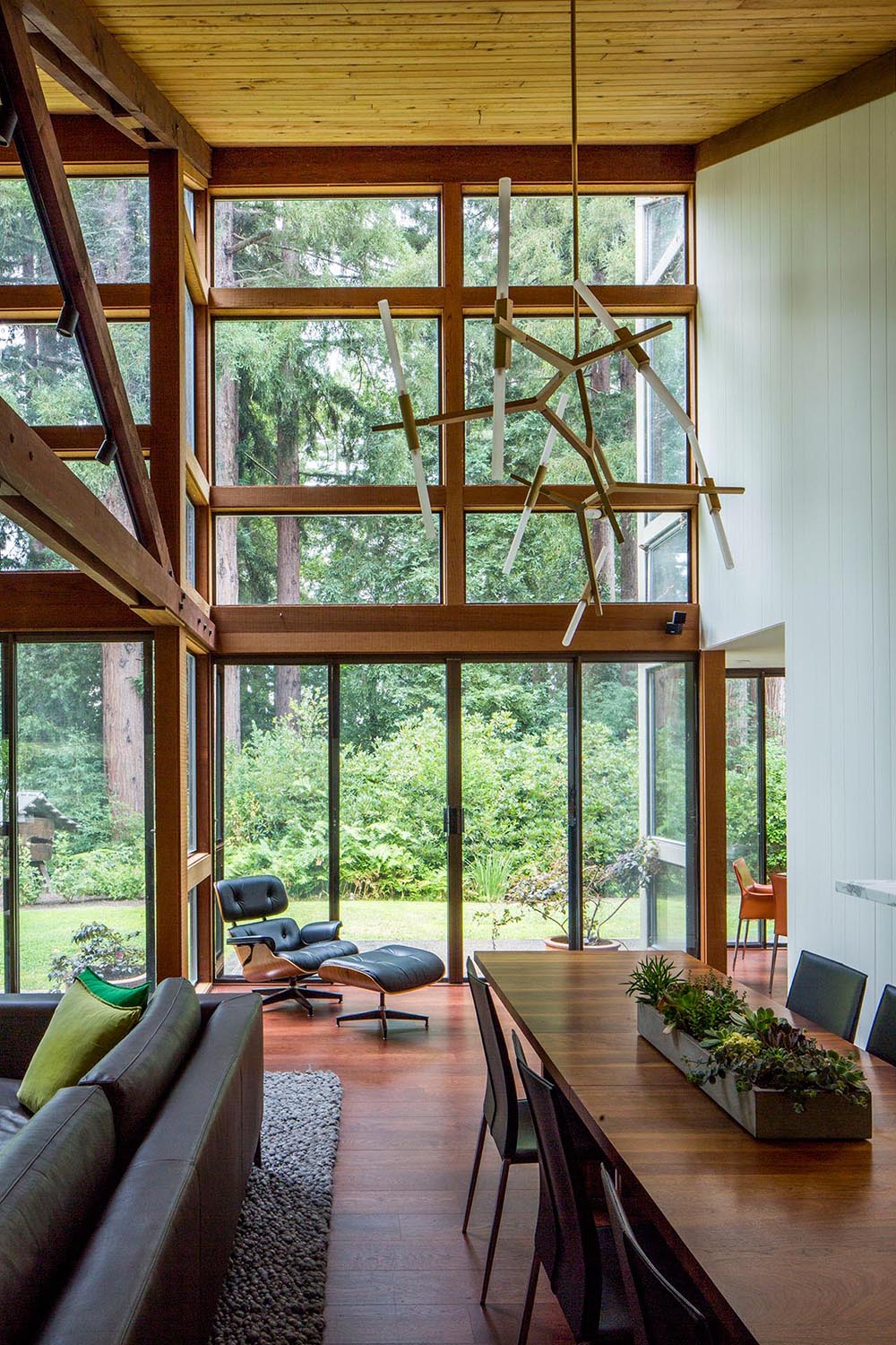 A modern open plan dining room with high ceilings and plenty of natural light.