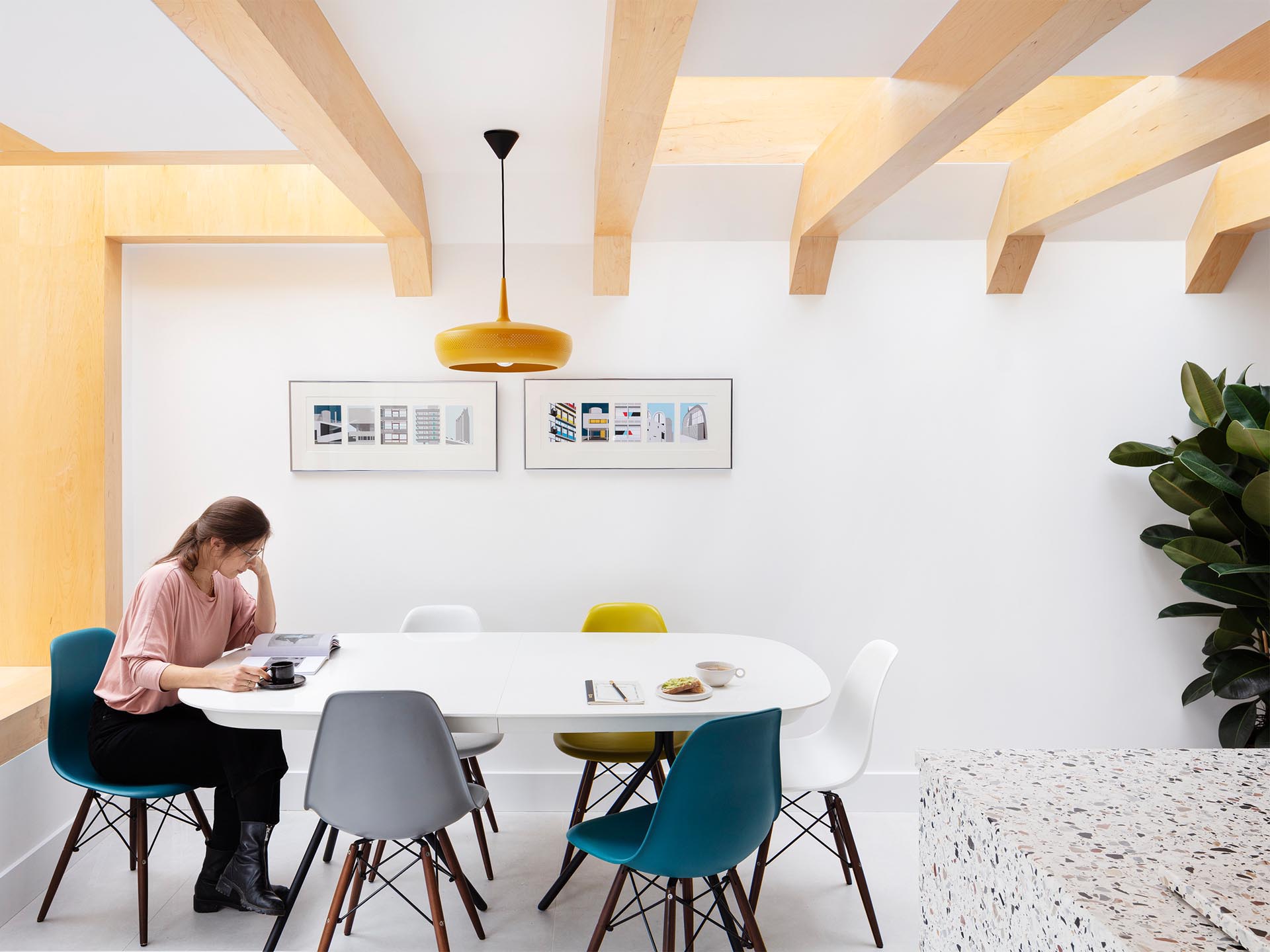 Warm wood beams are clearly visible against the white walls of the dining area.