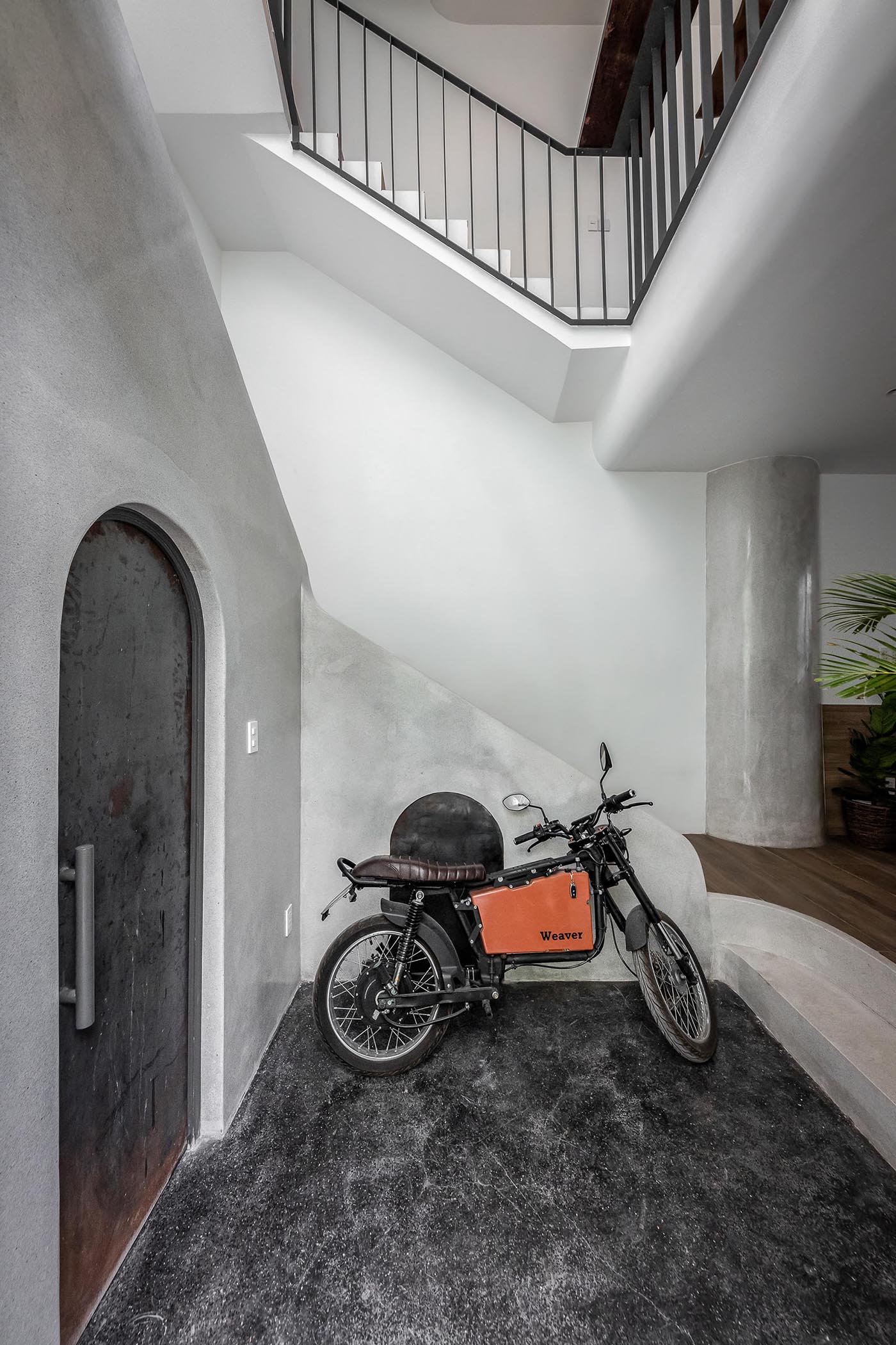 A modern entryway with room for motorbike storage.