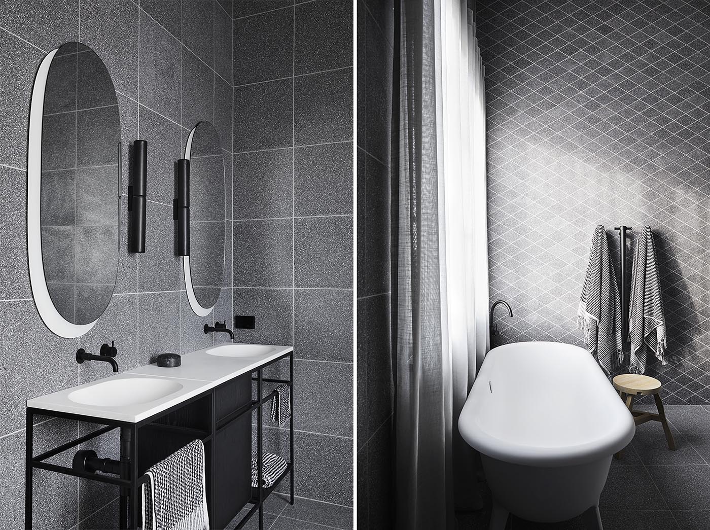 Modern grey and black bathrooms with terrazzo tile covered walls.