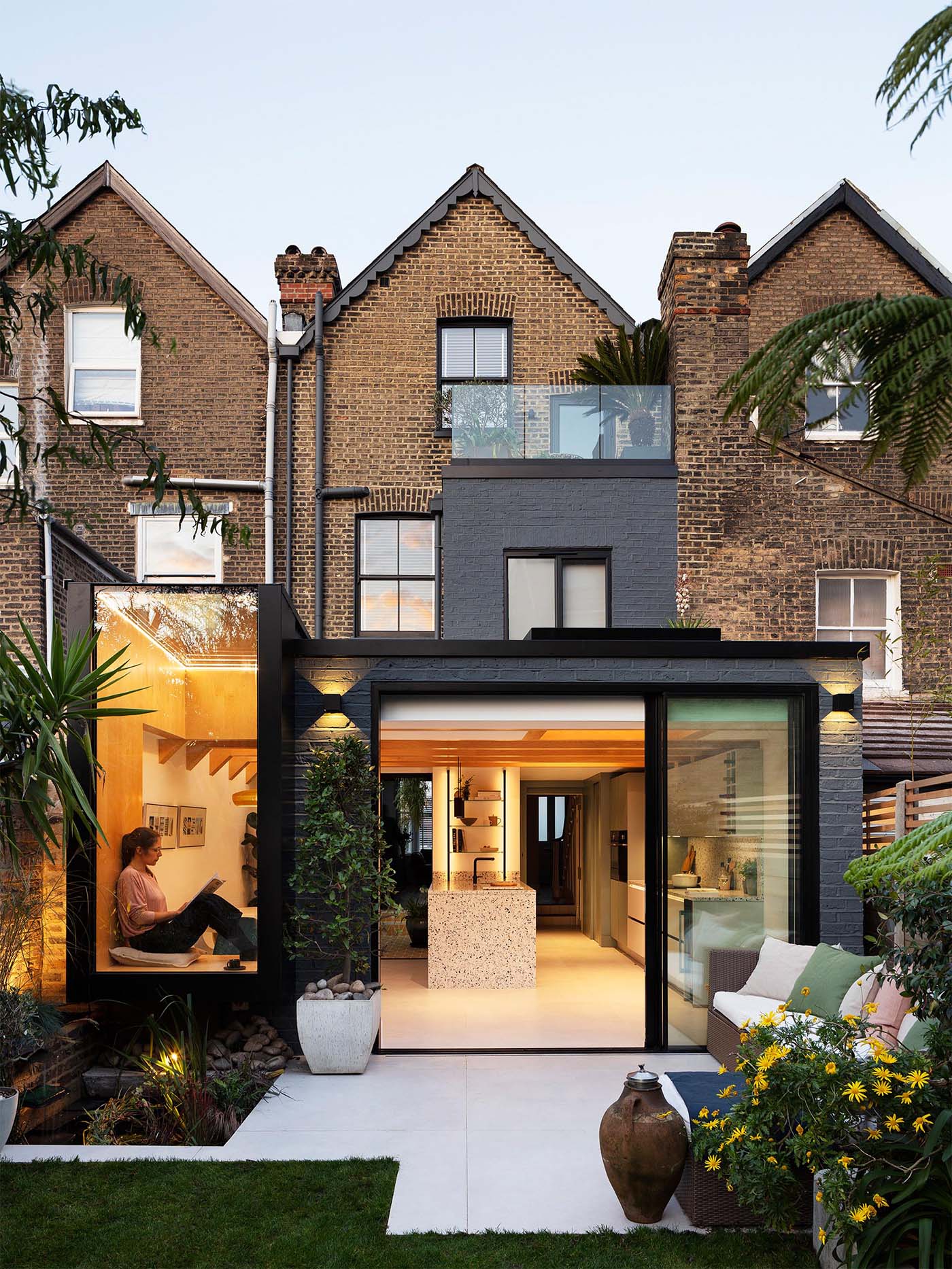 A side and rear extension for a Victorian mid-terrace house in London, England, that includes a window seat and an internal courtyard.