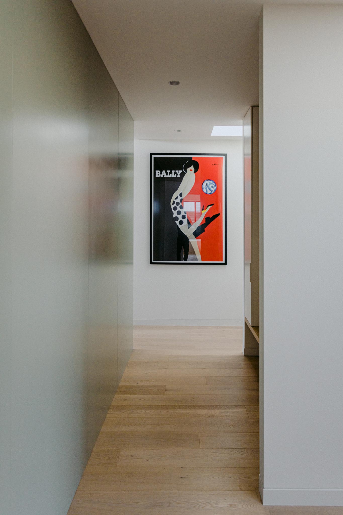 A modern entryway with wood flooring.