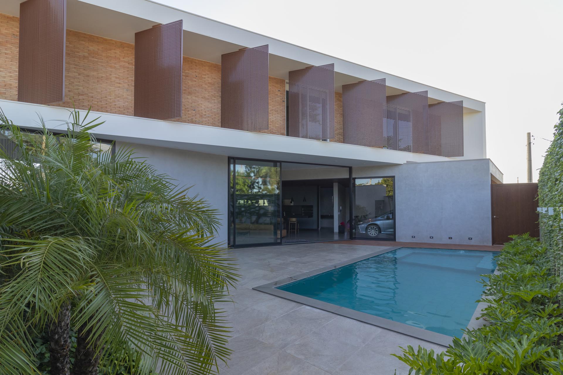 A modern house with a swimming pool and patio.