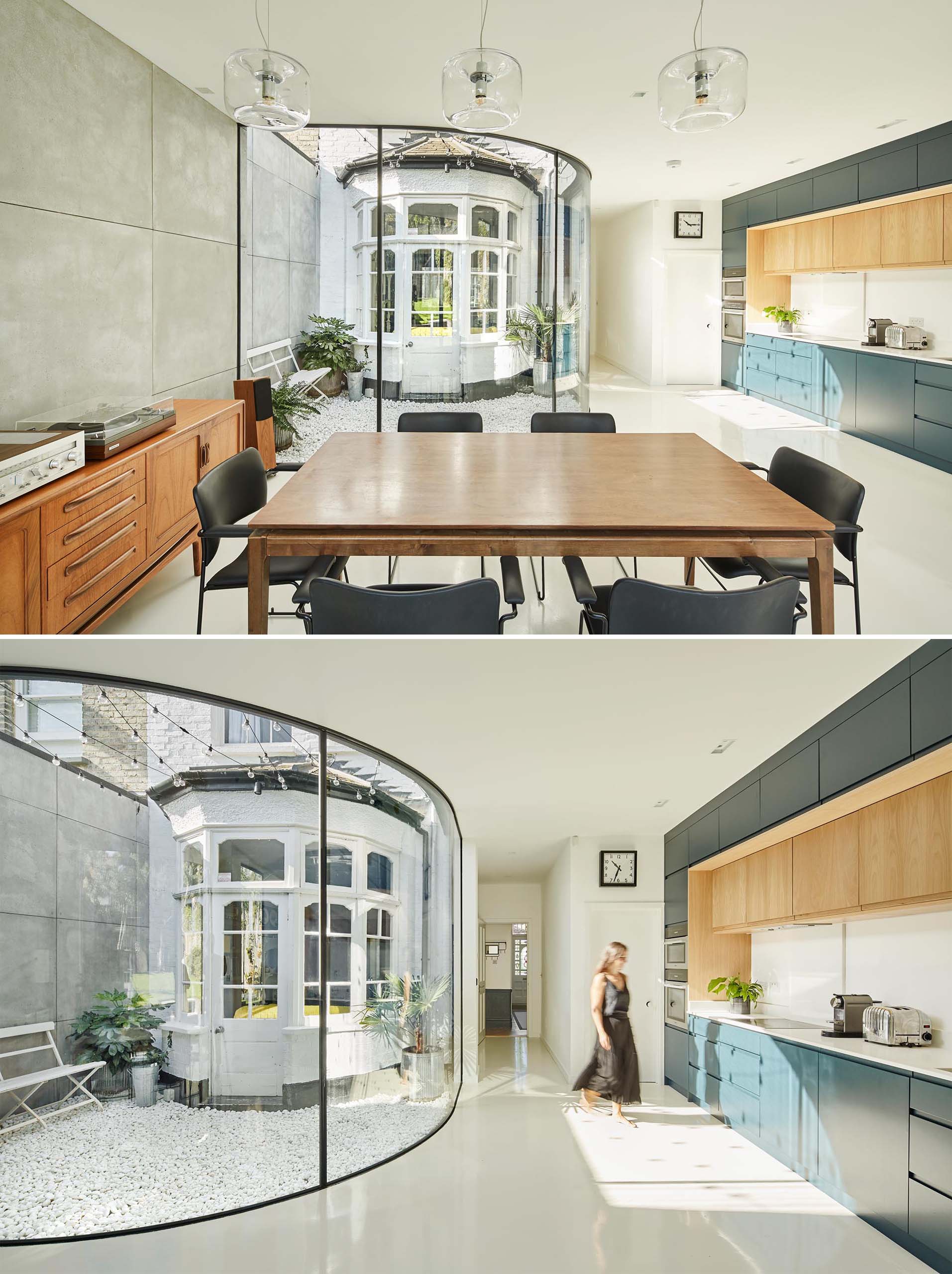 A modern rear extension with a new open plan dining room and kitchen, with the dark blue kitchen cabinets adding a colorful accent to the space. A curved window provides views of a small courtyard and original bay window.