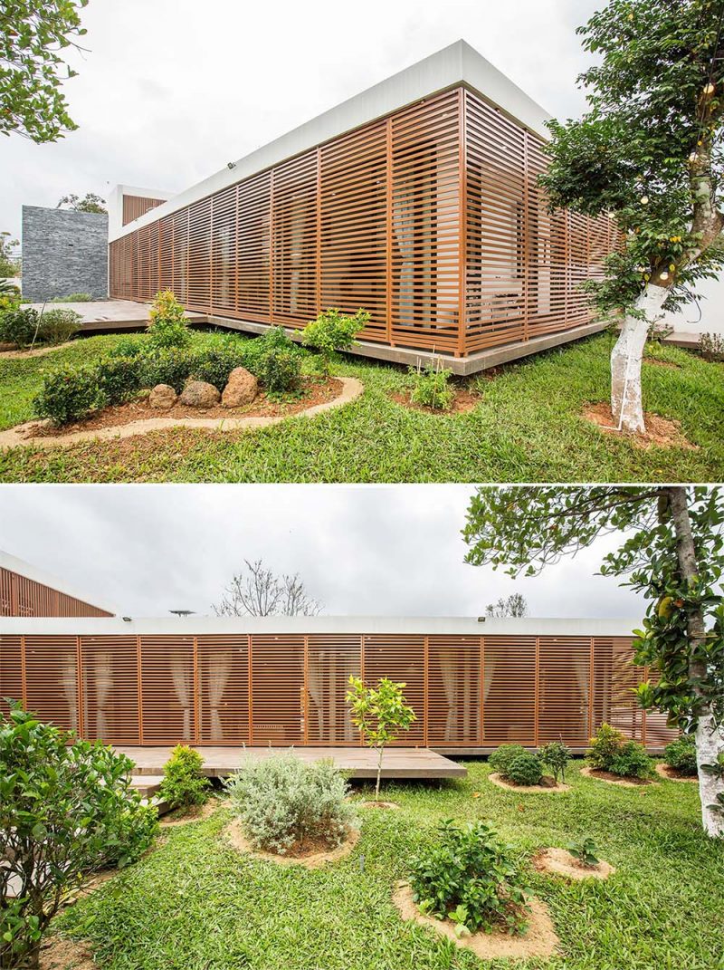 A modern house with operable metal screens that wrap around the exterior and provide an outdoor corridor.