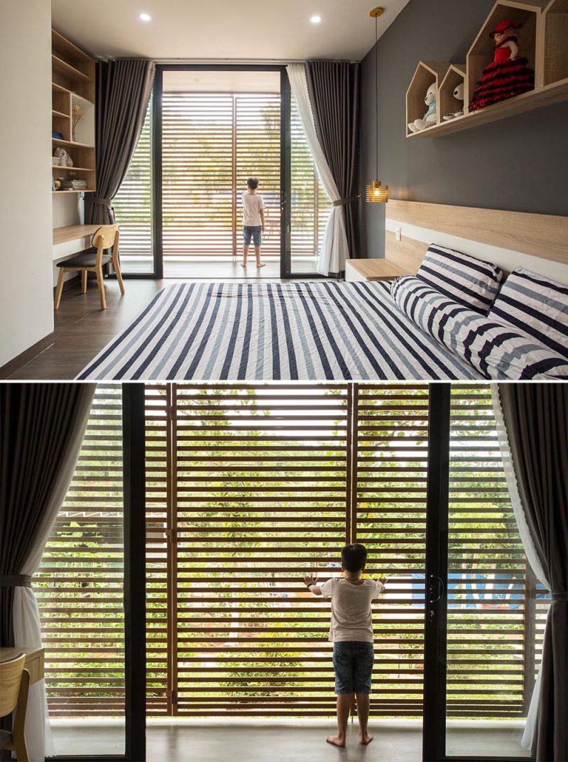 A modern kids bedroom that opens to an outdoor corridor with metal screens