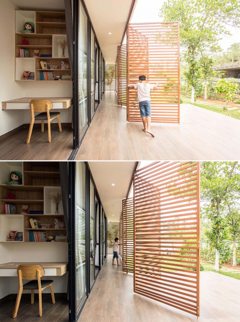 A modern house with operable metal screens that wrap around the exterior and create an outdoor corridor.