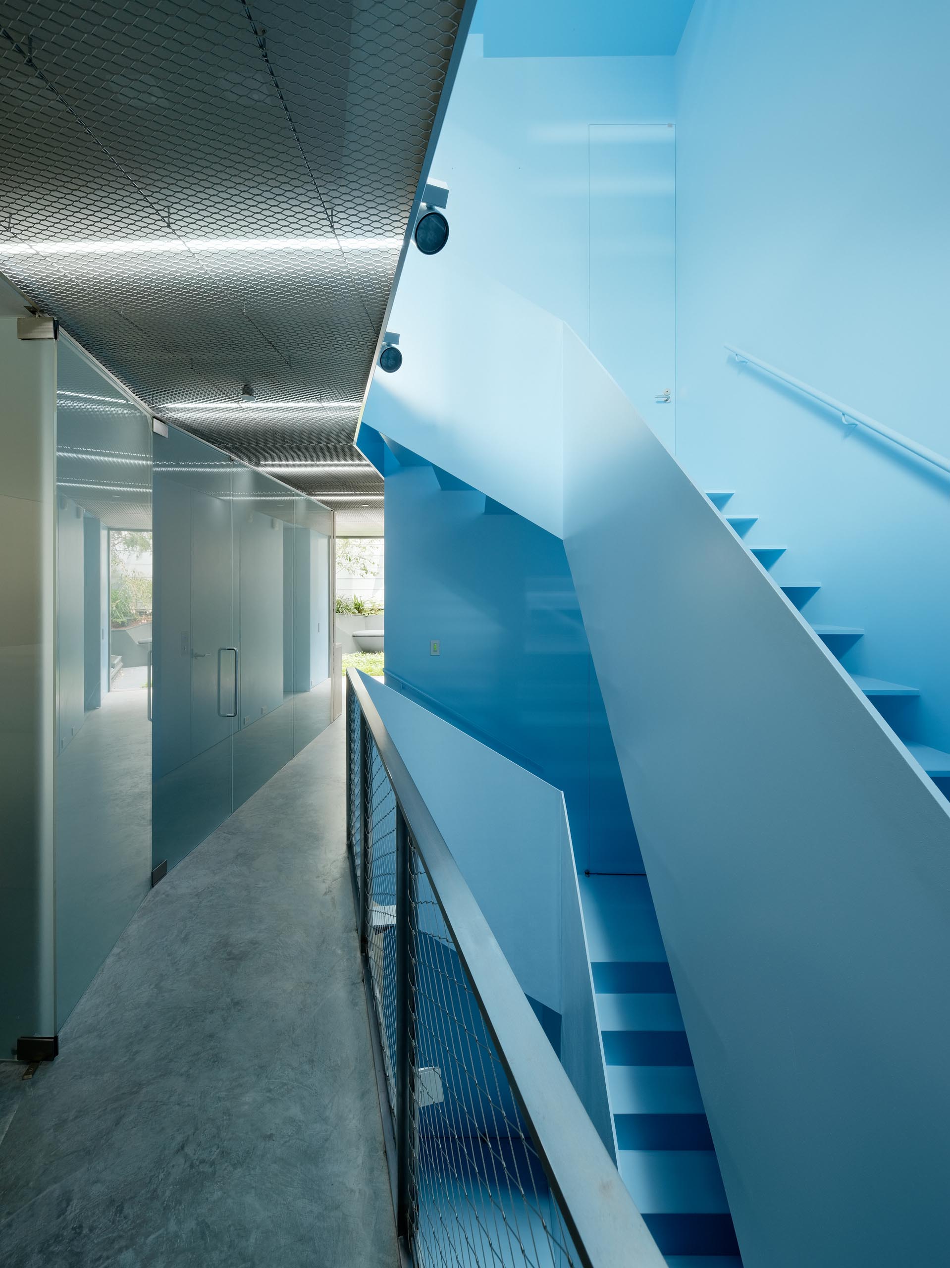 A modern home with a pastel blue staircase.