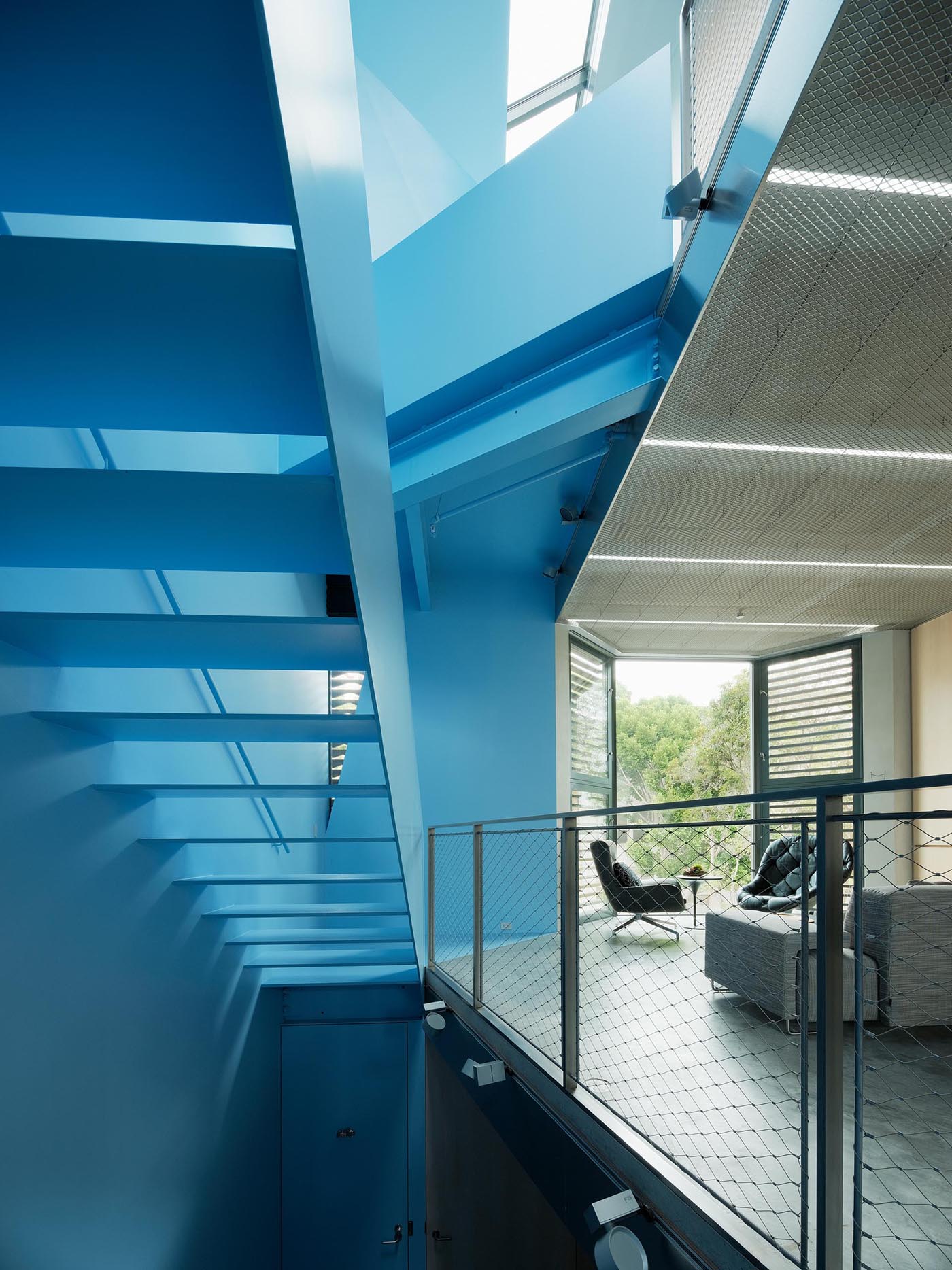 A modern home with a pastel blue staircase.