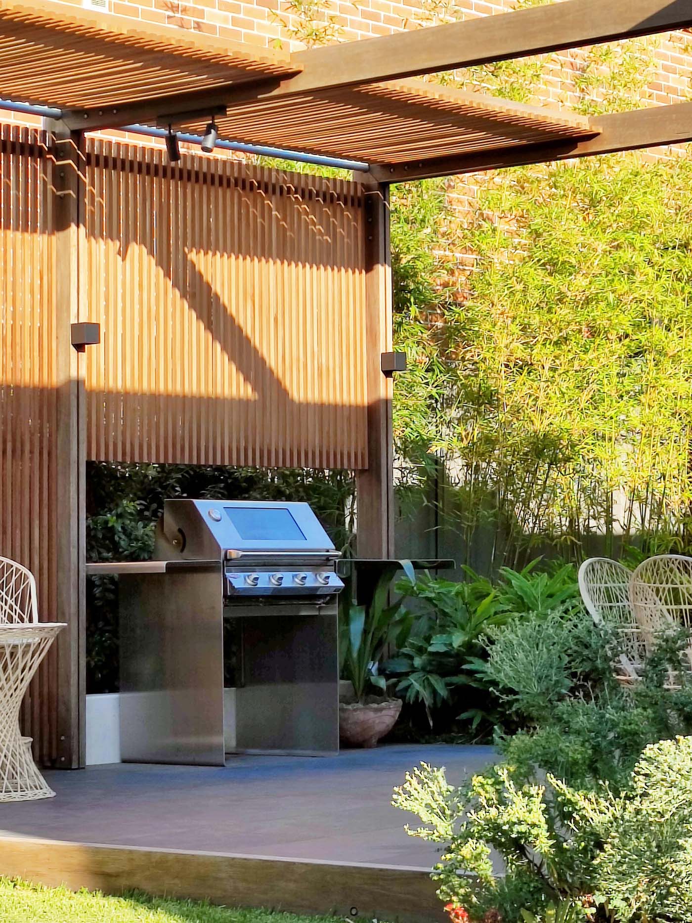 A modern partially covered outdoor bbq area.