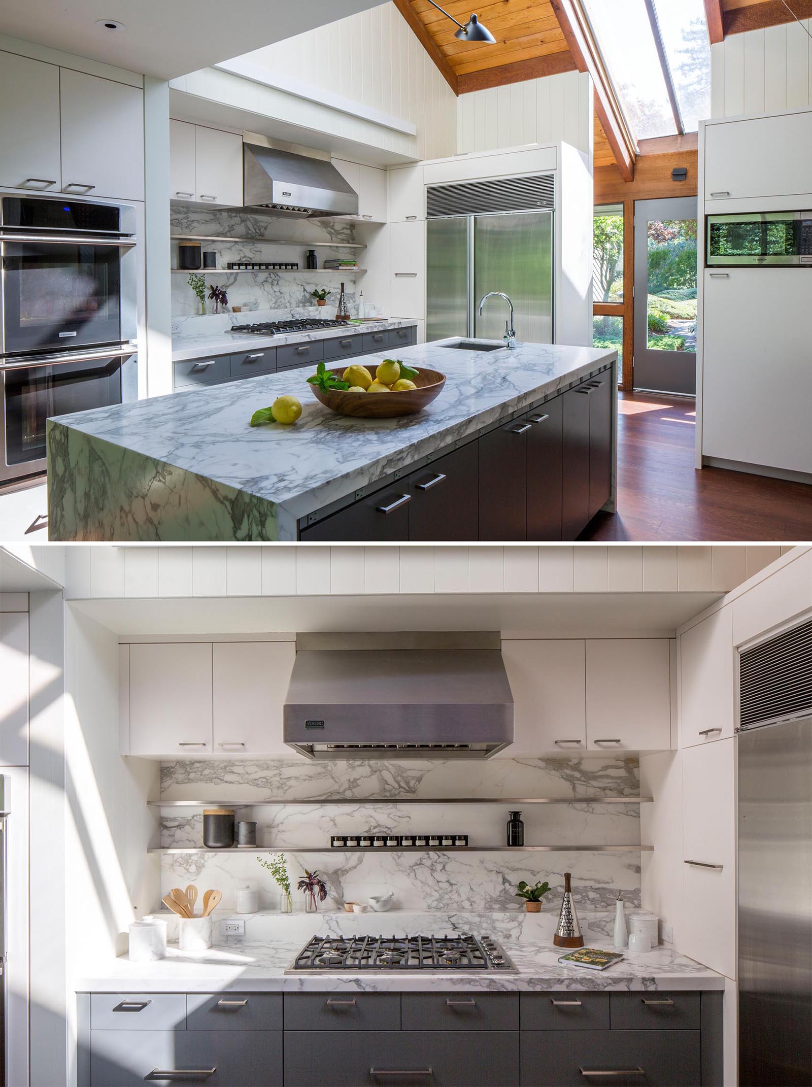 A modern kitchen which includes minimalist white and gray cabinets, a breakfast bar, and an island with a waterfall countertop.