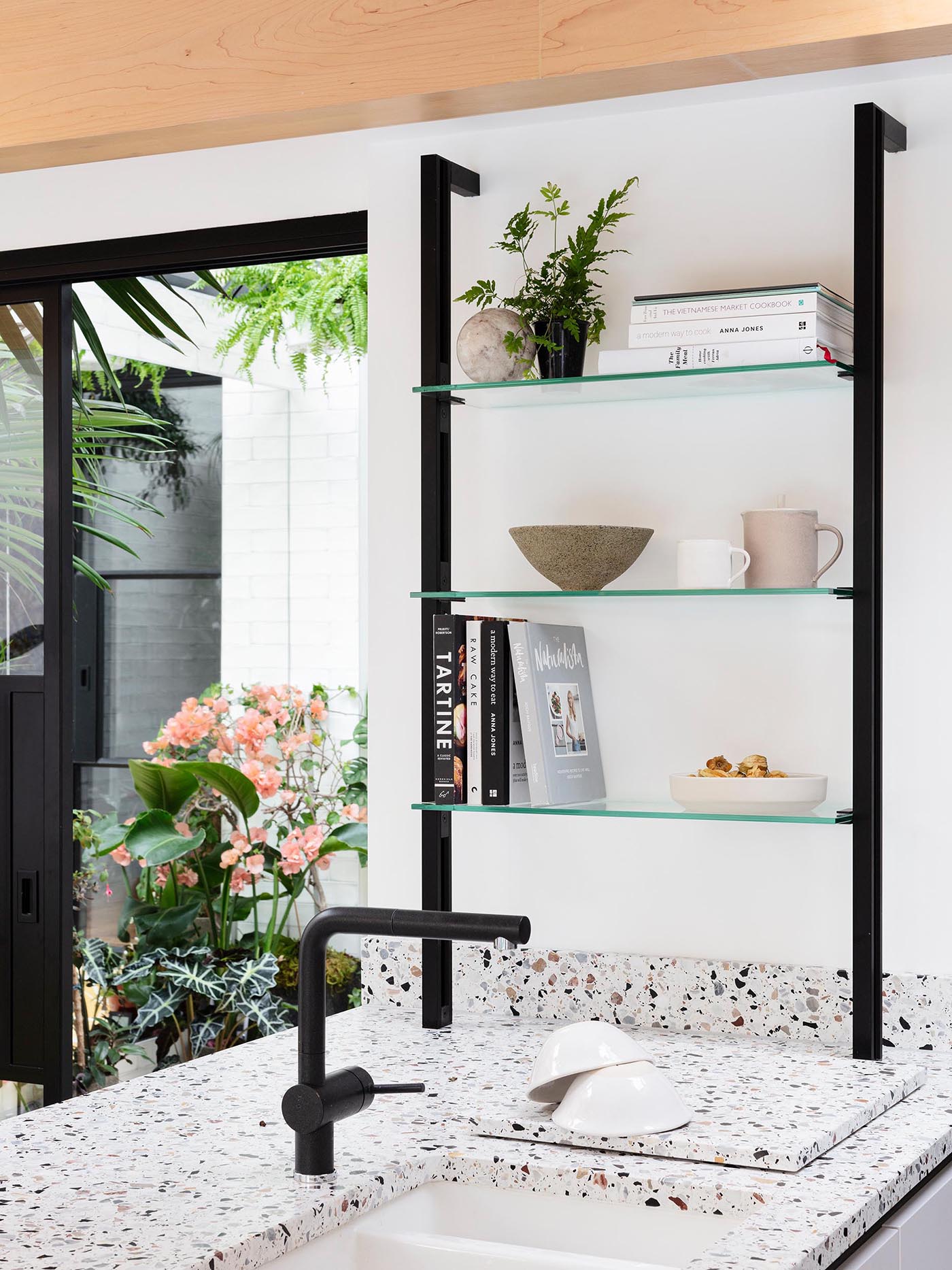 A modern kitchen with terrazzo that covers the island and countertops.