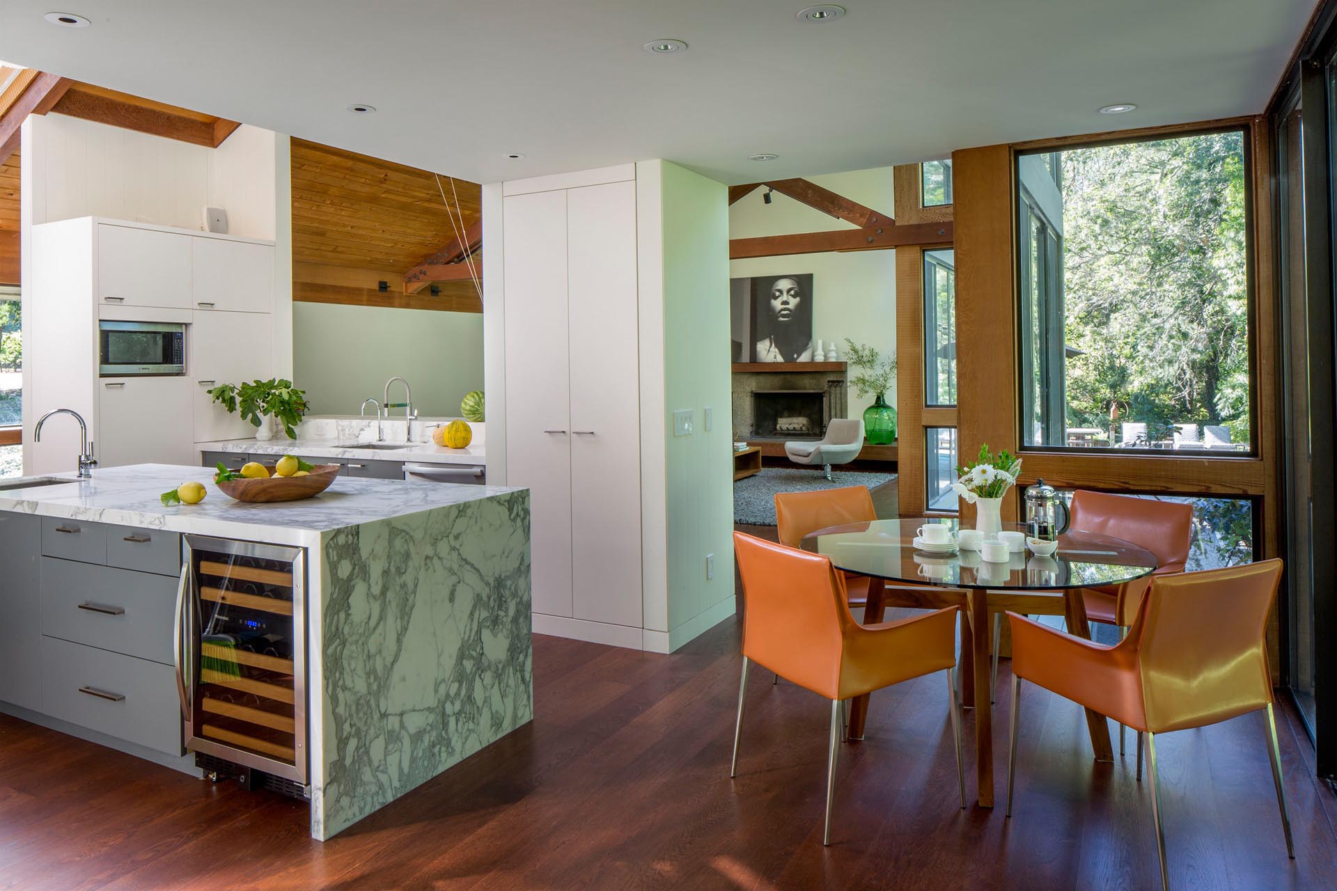 A small casual dining area with a round table and leather chairs.