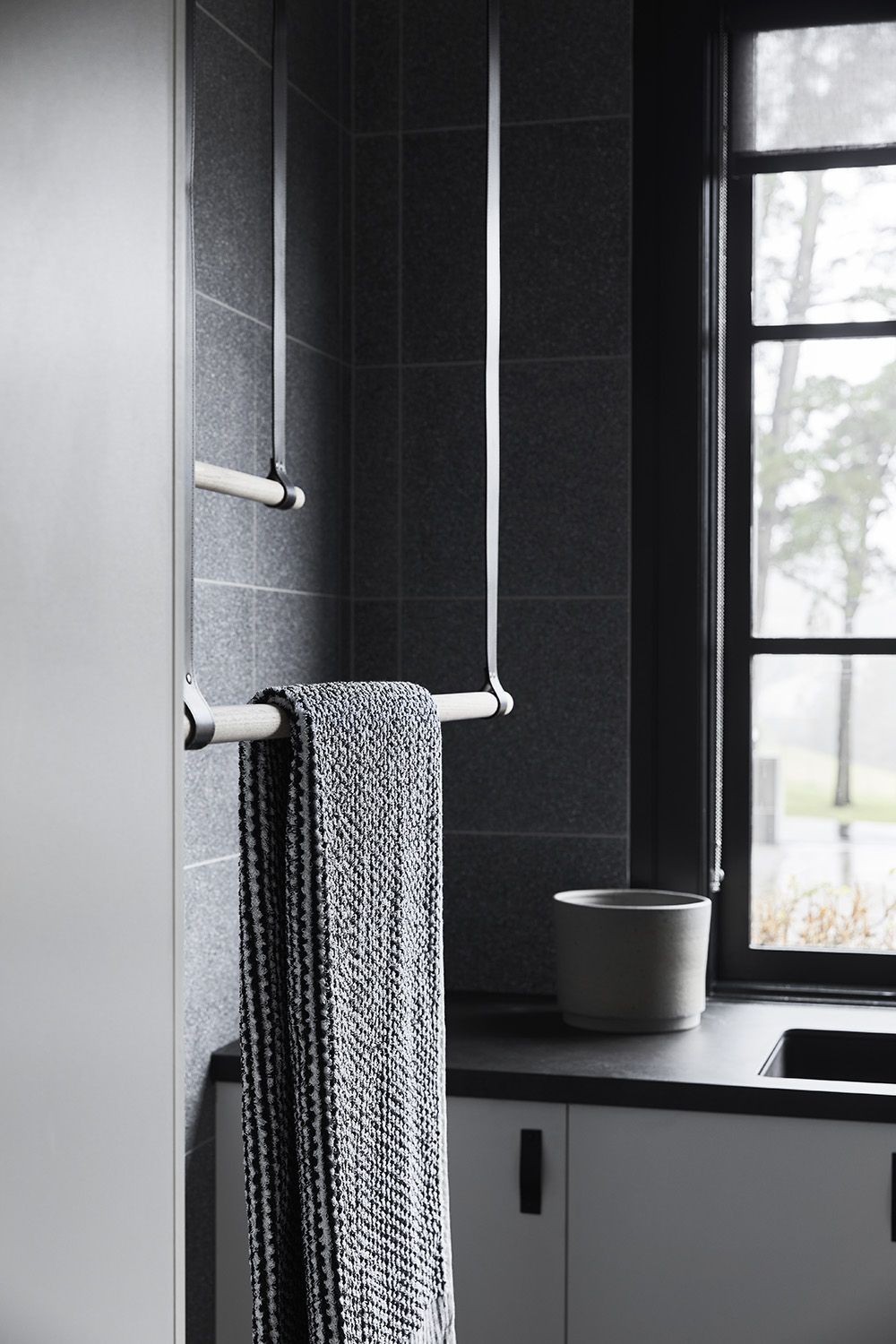 A modern laundry room with hanging bars for drying.